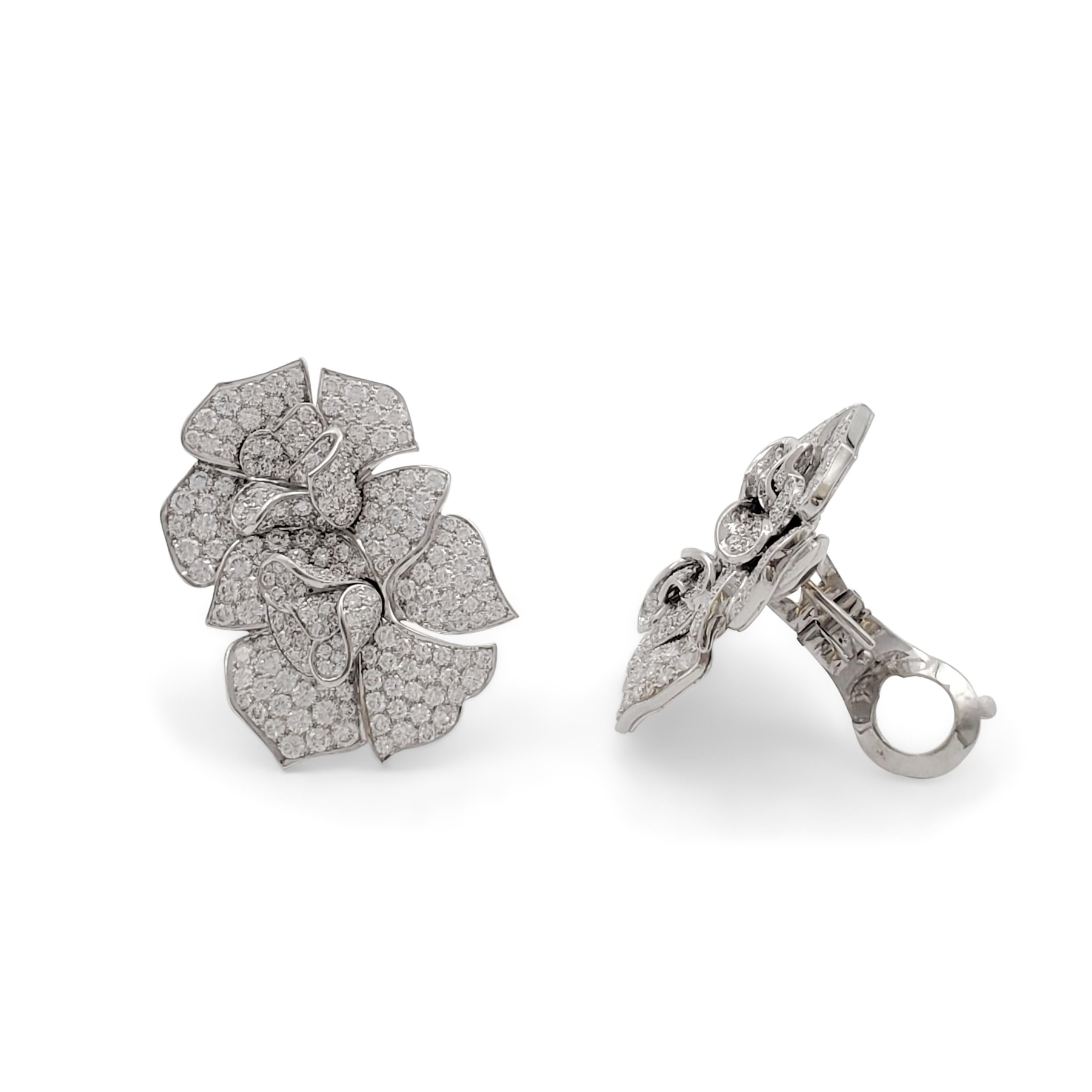 Authentic floral Van Cleef & Arpels ear clips crafted in 18 karat white gold and set with an estimated 11 carats of high-quality (E-F, VS) round brilliant cut diamonds. Signed Van Cleef & Arpels, 750, with serial number and French hallmarks. The