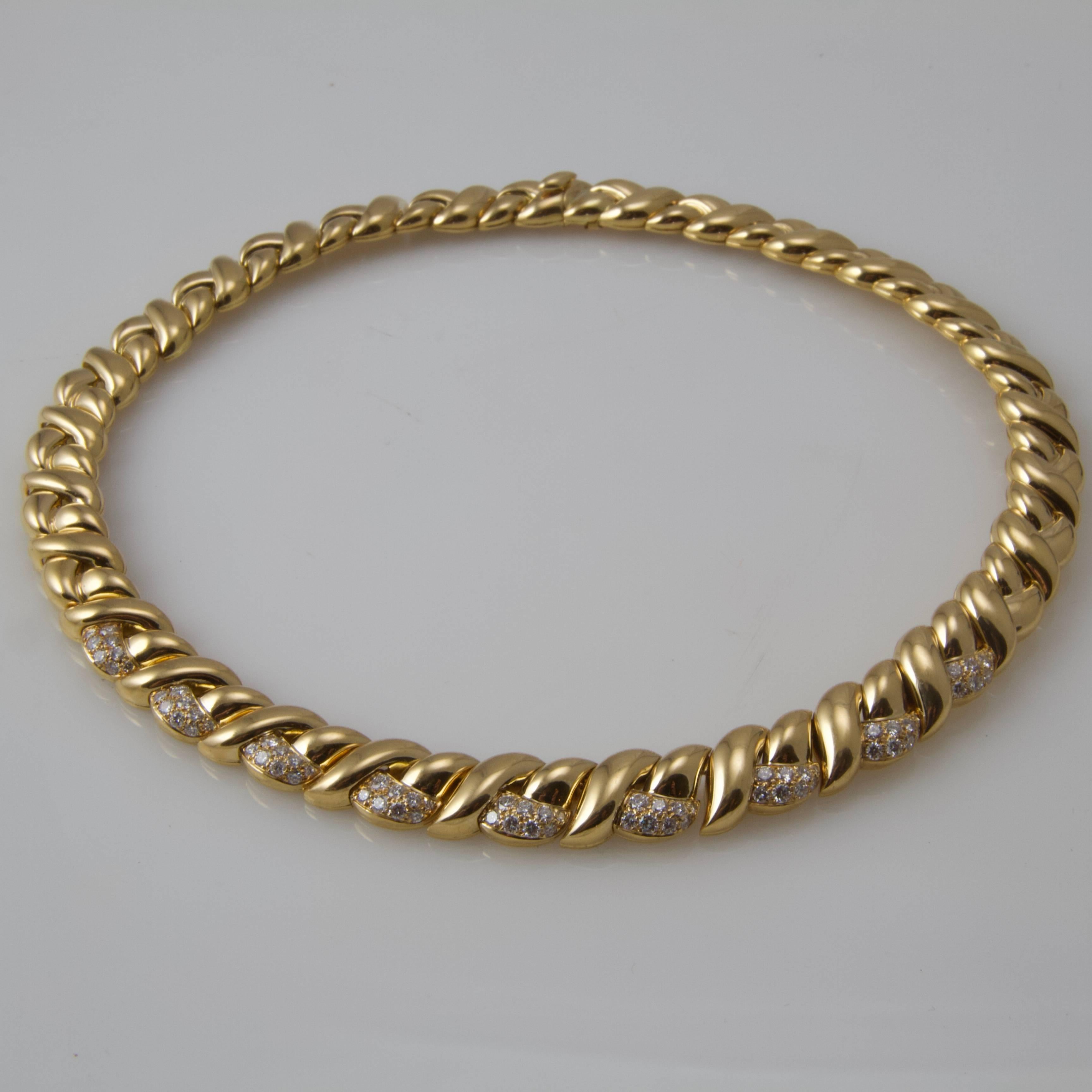 Waves pattern yellow gold and diamond necklace. 
Set on the nine central motif with round diamond (weight  2.25 carat engraved on the clasp)
Security system.
French maker's mark. 
French assays marks for 18kt.  
Signed on the clasp by Van Cleef &
