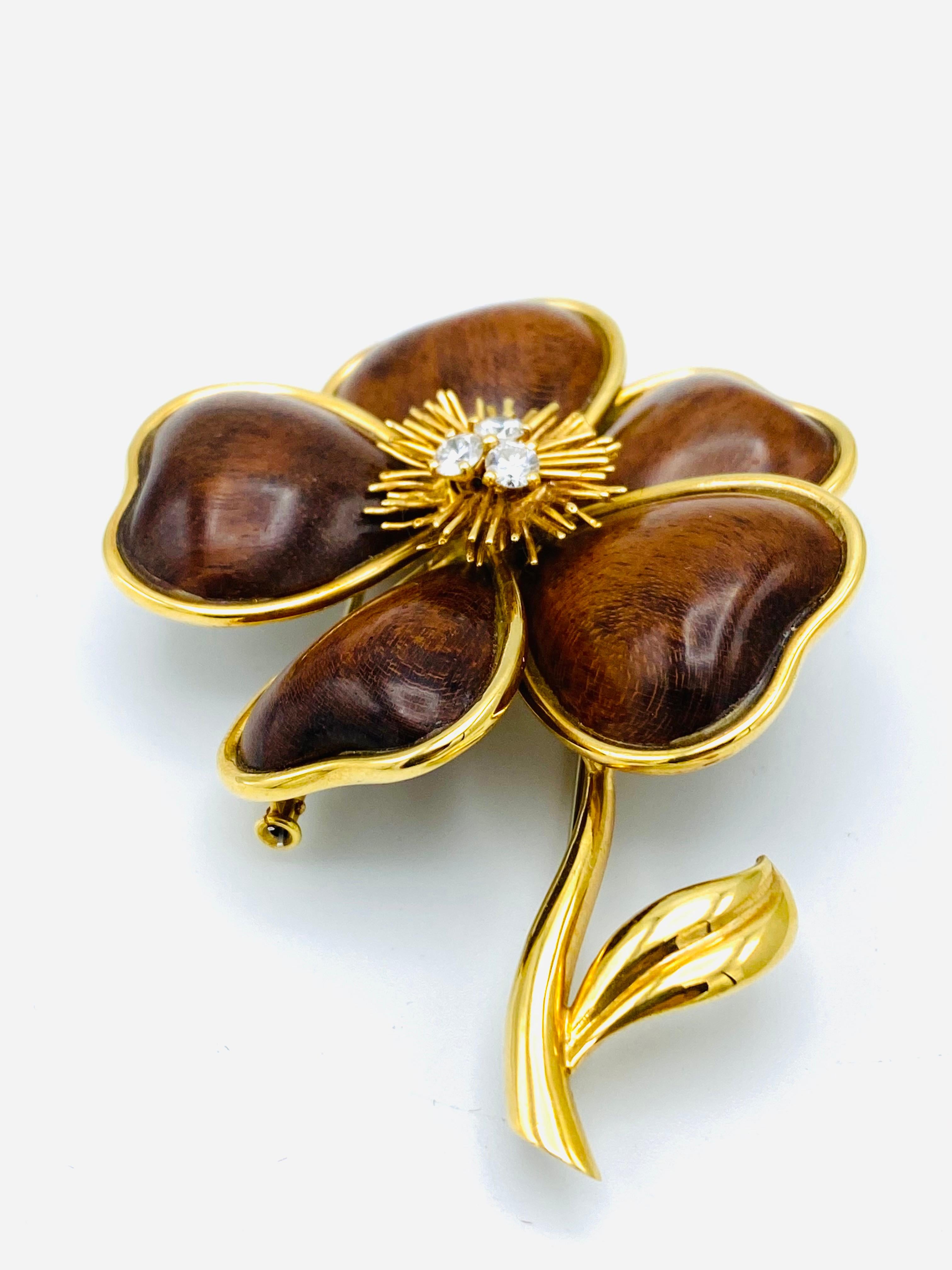 Product details:
Created by Van Cleef and Arpels in France in 1972’s. 
It is made of 18K yellow gold, amourette wood and accented with three round brilliant cut diamonds, total weight is 0.45 carat.
Stamped with VCA maker’s mark, hallmark for 18K