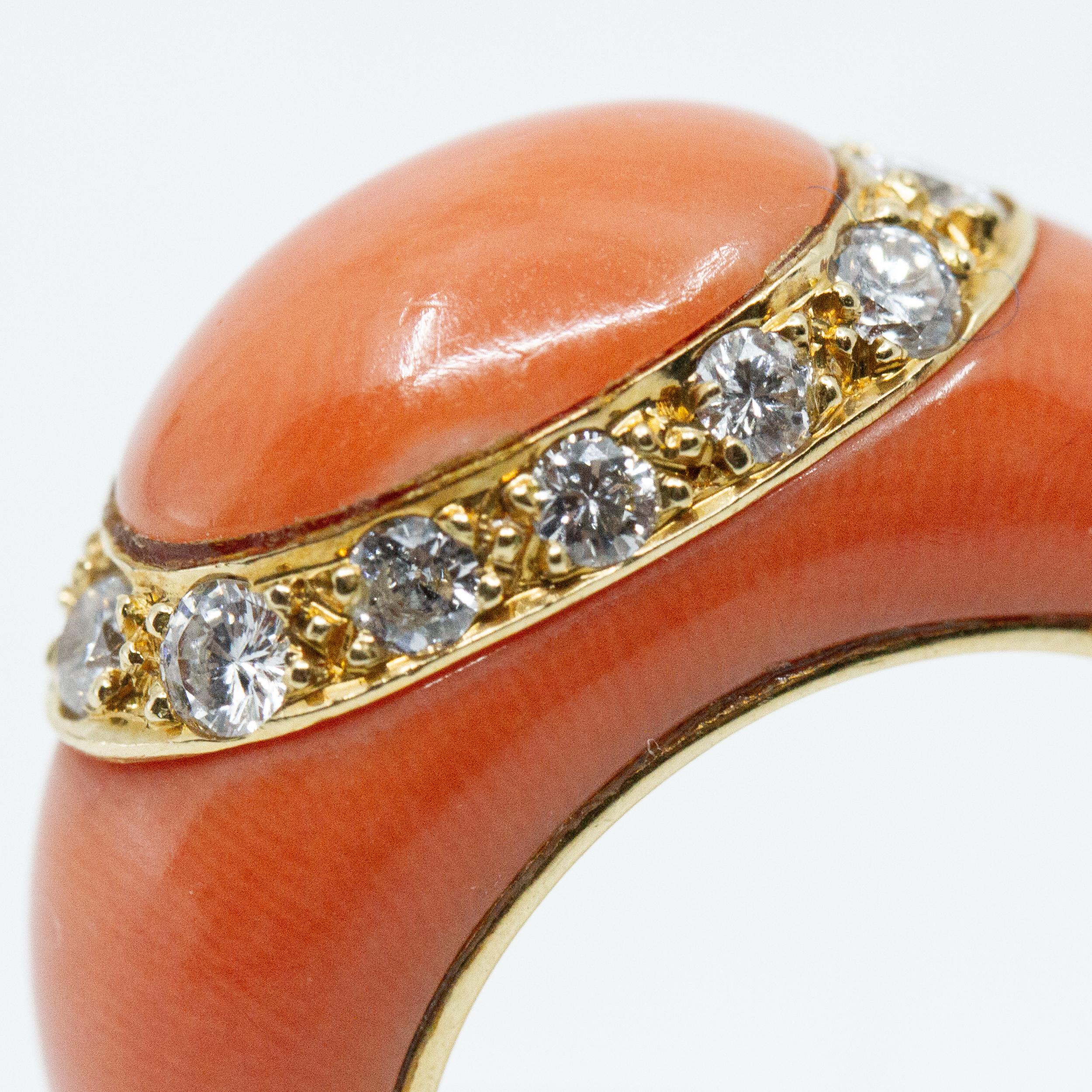 Van Cleef & Arpel 18kt yellow gold ring with carved salmon colored coral, accented with brilliant cut diamonds. Stamped: VCA 750 Made in France, French Assay Marks 5V63812. Approx. diamond weight .60ct, H-VS1, weighs 7.8 grams, size 4.5. 
About