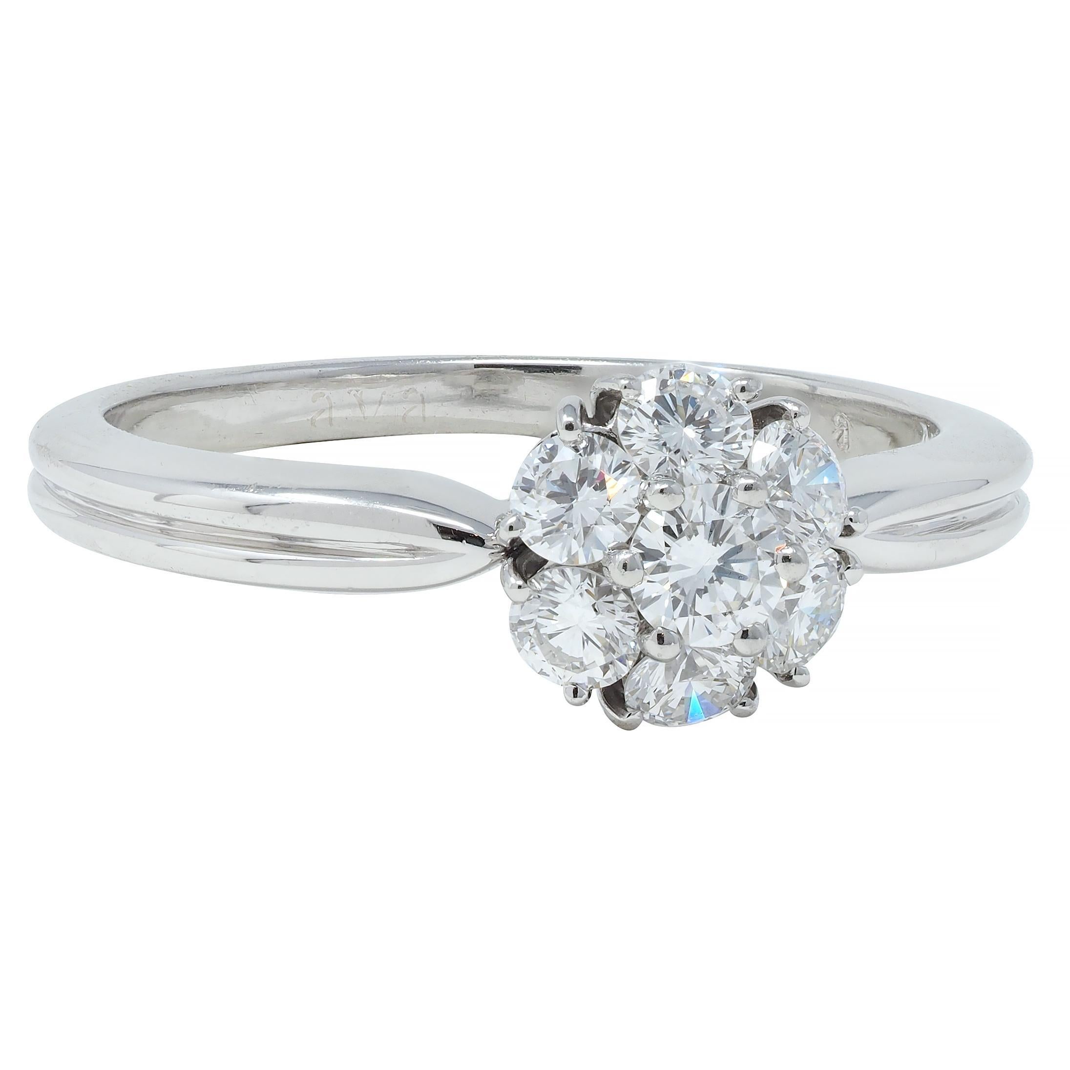 Featuring round brilliant cut diamonds clustered as a floral motif - weighing approximately 0.46 carat total 
G/H in color with VS clarity - all prong set 
Flanked by grooved tapered shoulders
Stamped for platinum
Numbered and fully signed Van Cleef