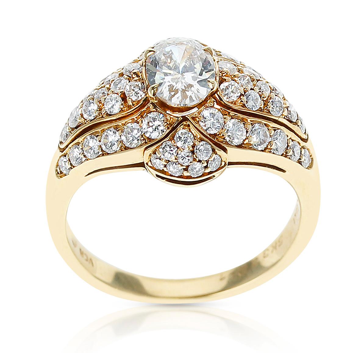 A Van Cleef & Arpels Oval Diamond Ring accented with Diamonds on the mounting made in 18 Karat Yellow Gold. The center diamond is approximately 0.55 carats. Ring Size US 6.25. Total Weight: 5.37 grams. 

