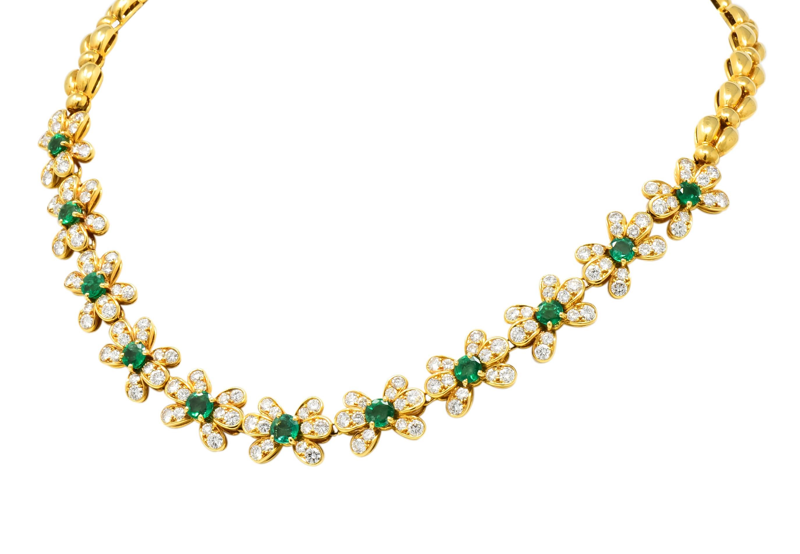 Necklace designed with eleven floral stations, each centering a round cut emerald weighing 4.40 carats total, transparent and vividly green in color

Emeralds surrounded by petals set with round brilliant cut diamonds weighing 6.34 carats total, E-F