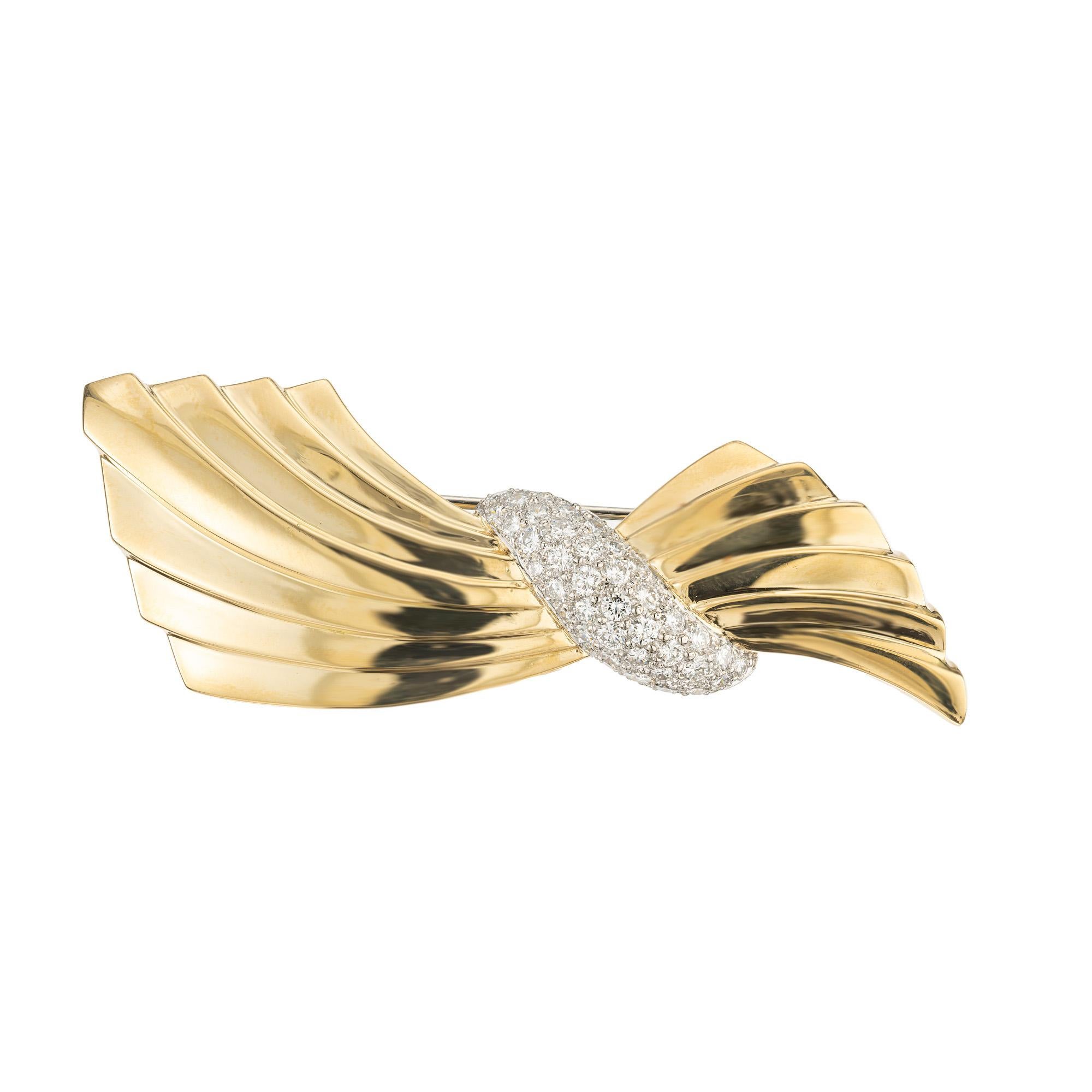 Experience timeless elegance with the Van Cleef & Arpels 1.60 carat diamond swirl gold brooch, a masterpiece that exudes sophistication and charm. This exquisite piece is a harmonious blend of meticulous craftsmanship and opulent design that Van