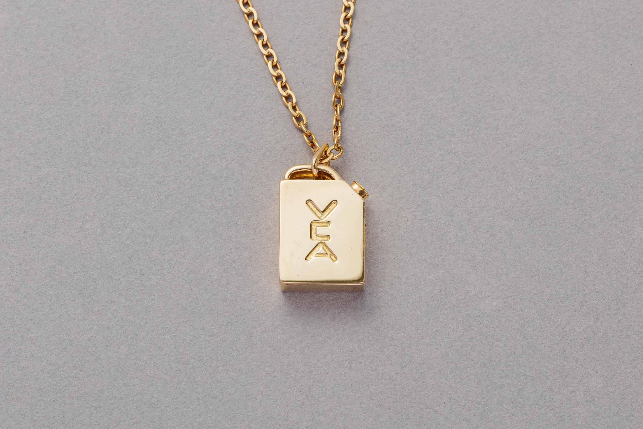 An 18 carat gold vintage gas tank locket pendant by Péry Fils for Van Cleef and Arpels, signed, dated and numbered: Van Cleef & Arpels, on a Van Cleef & Arpels chain, 1976.  Relevant in the 1970s because just as now there was an energy crisis. Van