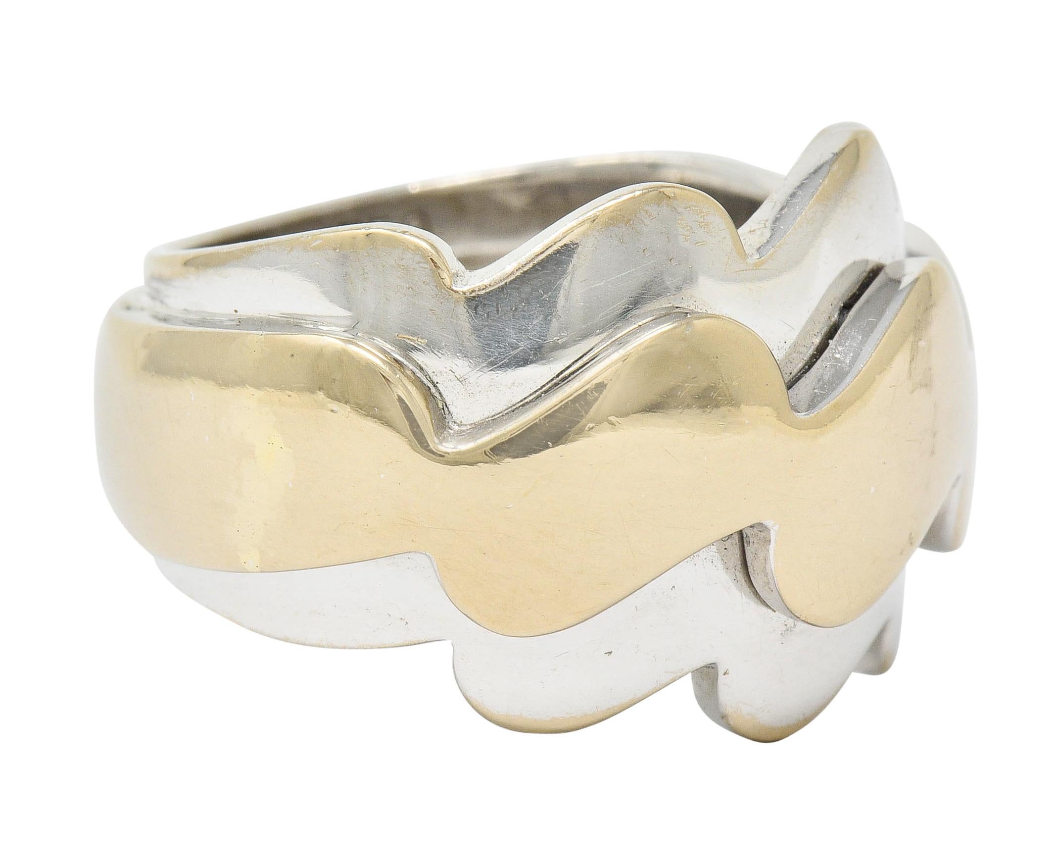 Two-tone gold band ring is designed as three waved segments

Central wave is raised and a muted yellow gold color that is flanked North and South by white gold waves

Numbered and signed VCA with maker's mark

Stamped 750 and with French assay mark