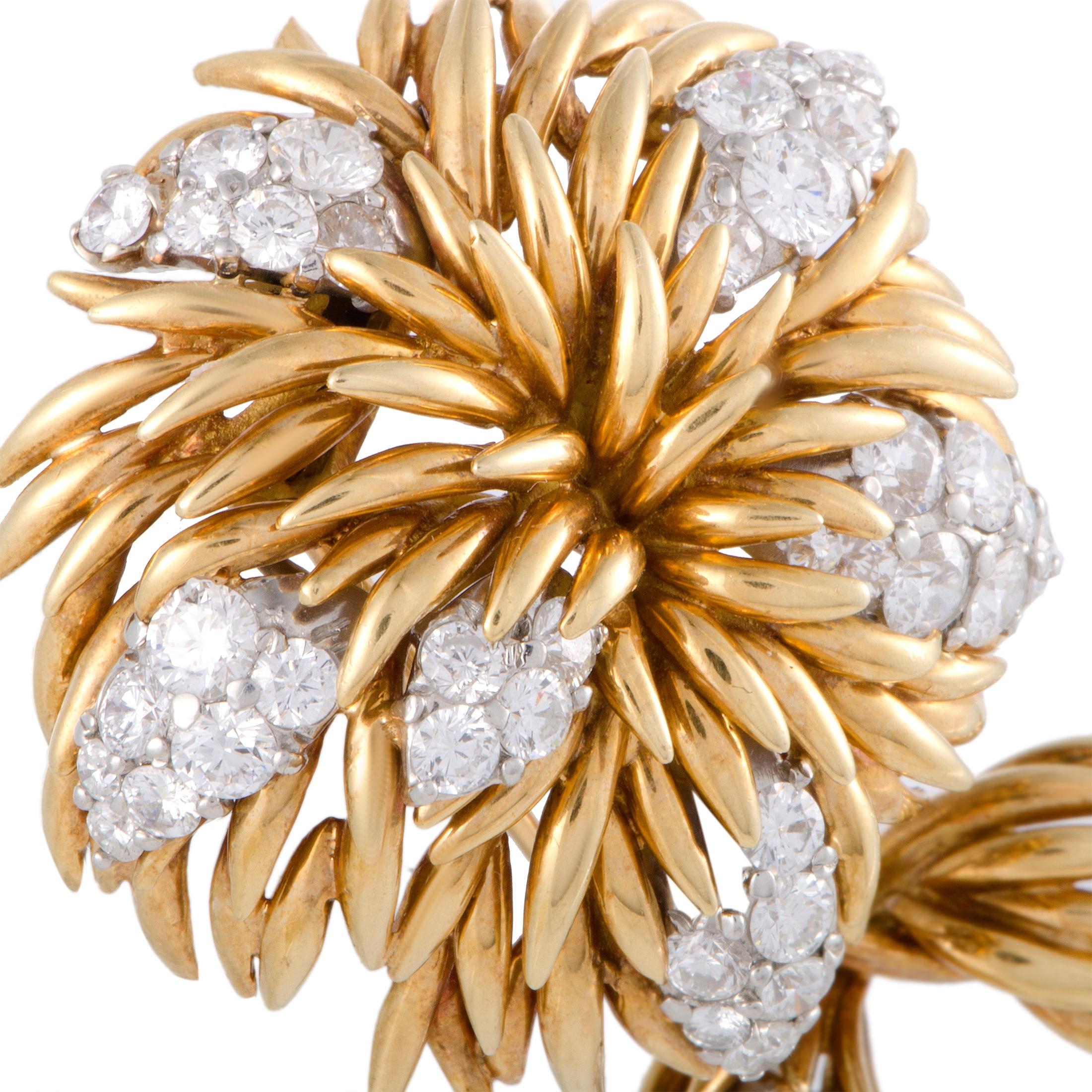 A stunningly intriguing design is beautifully presented in 18K yellow and 18K white gold in this superb brooch that is created by Van Cleef & Arpels. The brooch is luxuriously decorated with colorless (grade E) diamonds of VVS clarity that amount to