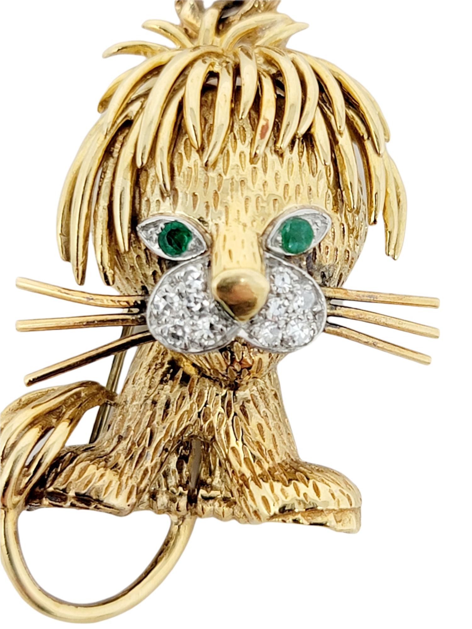 Stunningly detailed lion cub brooch accented with glittering diamonds and emeralds. Made of solid 18 karat yellow gold, this exquisite piece by Van Cleef & Arpels is a work of art and a fantastic conversation piece. 2 natural green emeralds act as