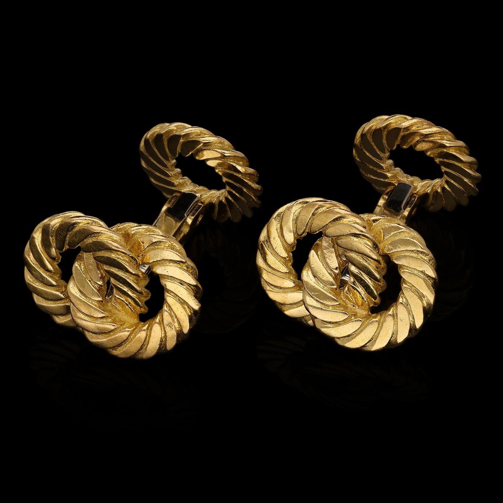 A pair of 18ct gold double ended cufflinks by Van Cleef & Arpels c.1970s, the cufflinks with a square section solid bar link terminated at one end by a single open circle formed of rope twist gold, the other with two similar circles entwined to form