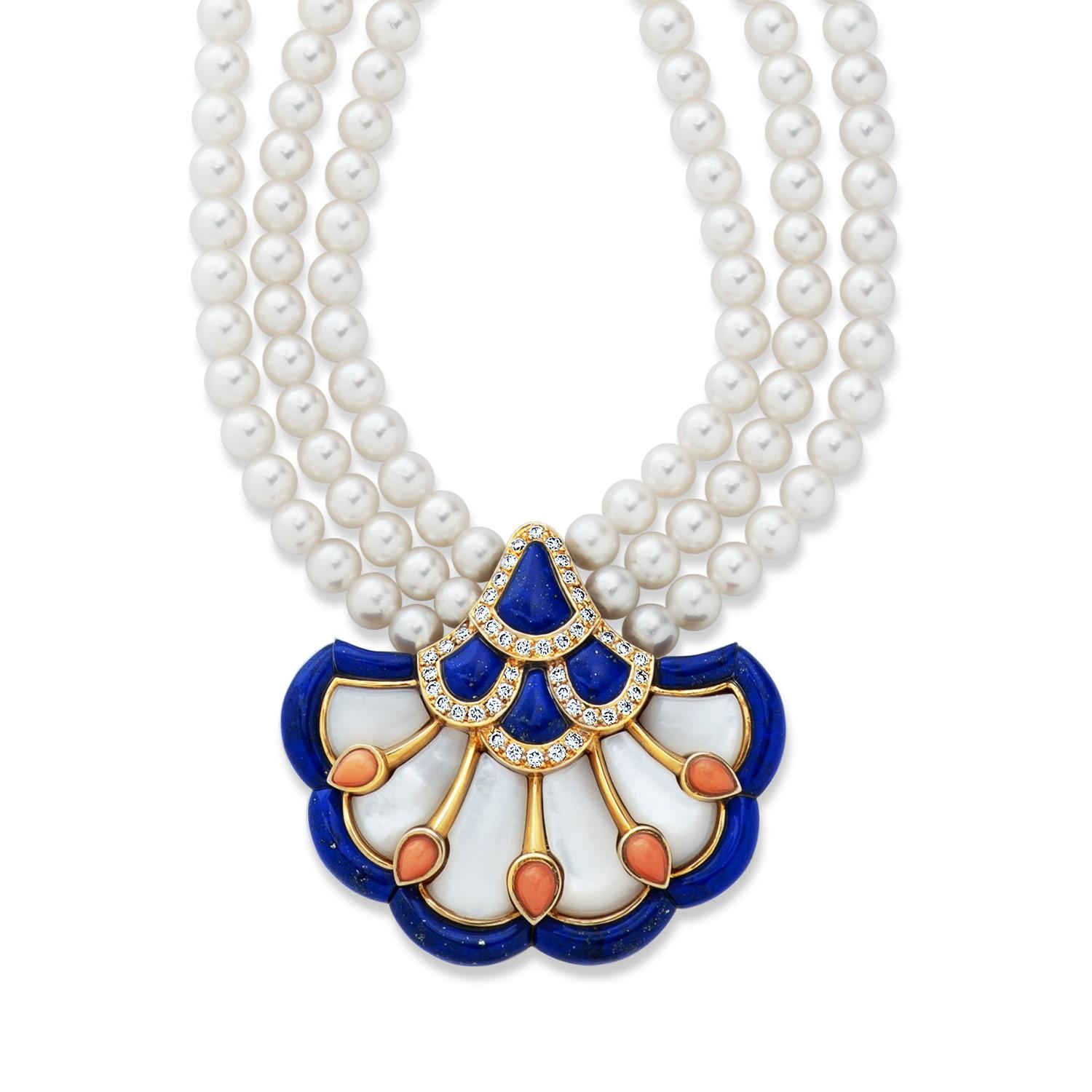 This rare vintage Van Cleef & Arpels 18kt yellow gold pendant/brooch is set with 0.82 carat of round diamonds, as well as coral, mother of pearl and lapis lazuli.  It can be worn hanging from its accompanying multi-strand pearl necklace, or alone as