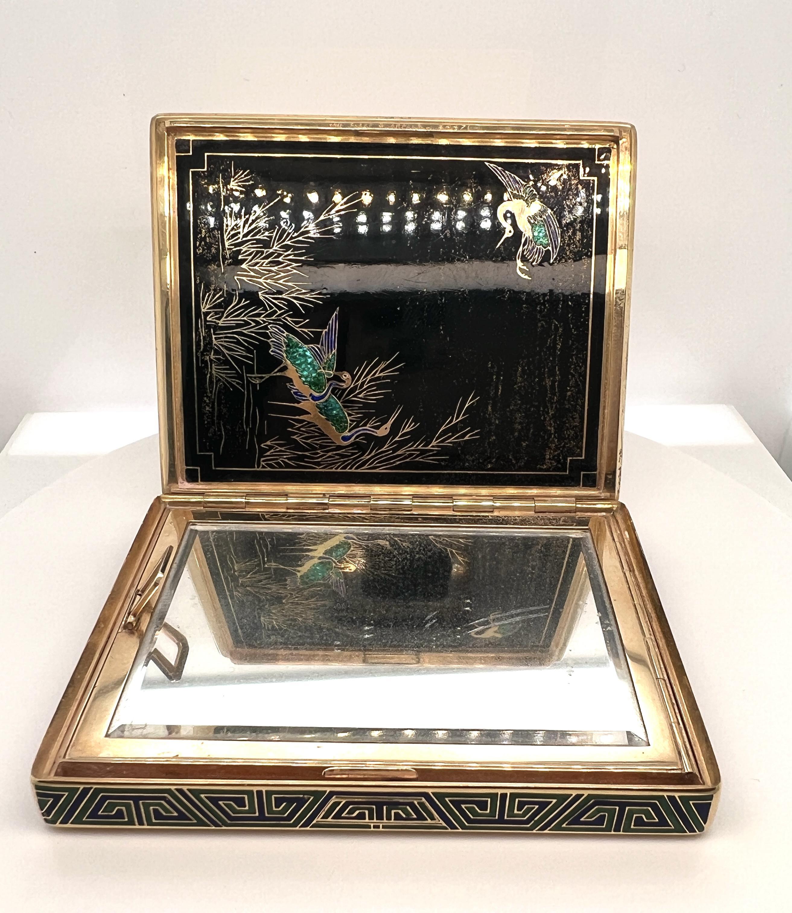 Van Cleef & Arpels 18k Gold And Enamel Compact.

The gold checkered and spiral design case accented by edges of blue and green enamel decoration opening to reveal a fitted mirror and interior two-compartment section completed by a panel of black