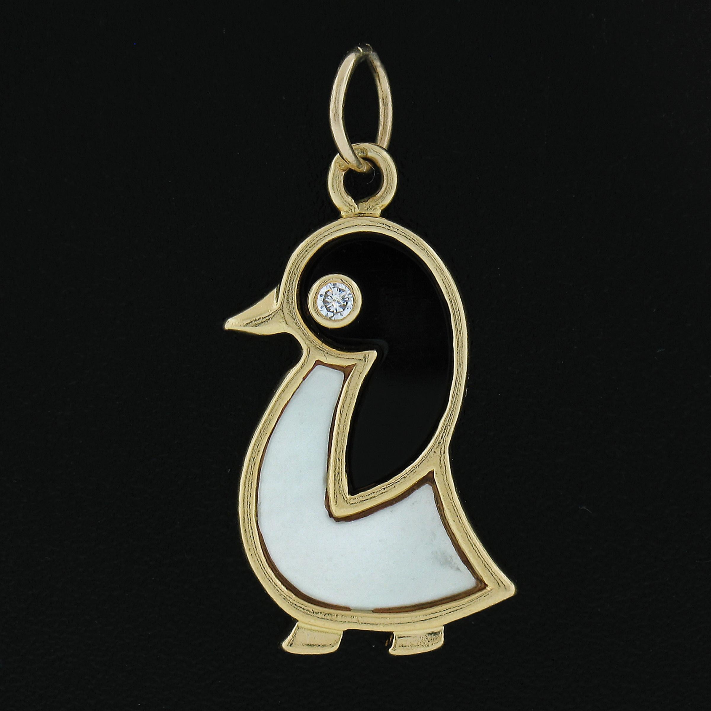 This adorable charm/pendant by Van Cleef & Arpels features custom cut black onyx and mother of pearl stones to create this cute penguin. The eye of the penguin is also set with a round brilliant cut diamond while the entire frame is crafted in solid
