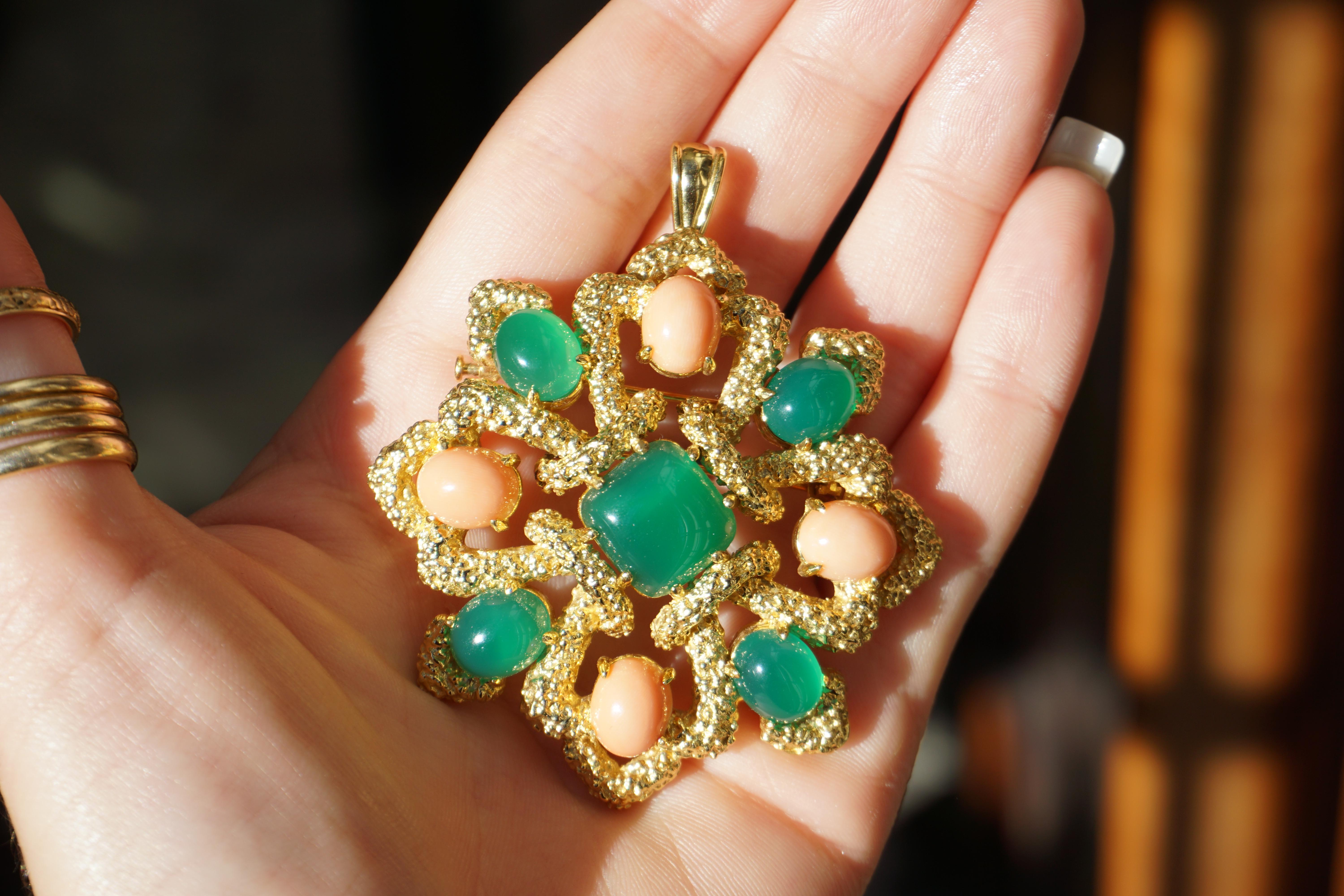 Doubling as a Brooch or a Pendant, featuring Natural Chrysoprase & Natural Angelskin Coral - crafted completely in 18 Karat Yellow Gold, clearly in multiple techniques of gold-smithing.. In a multi-level convex design. 
Gemstones consisting of a