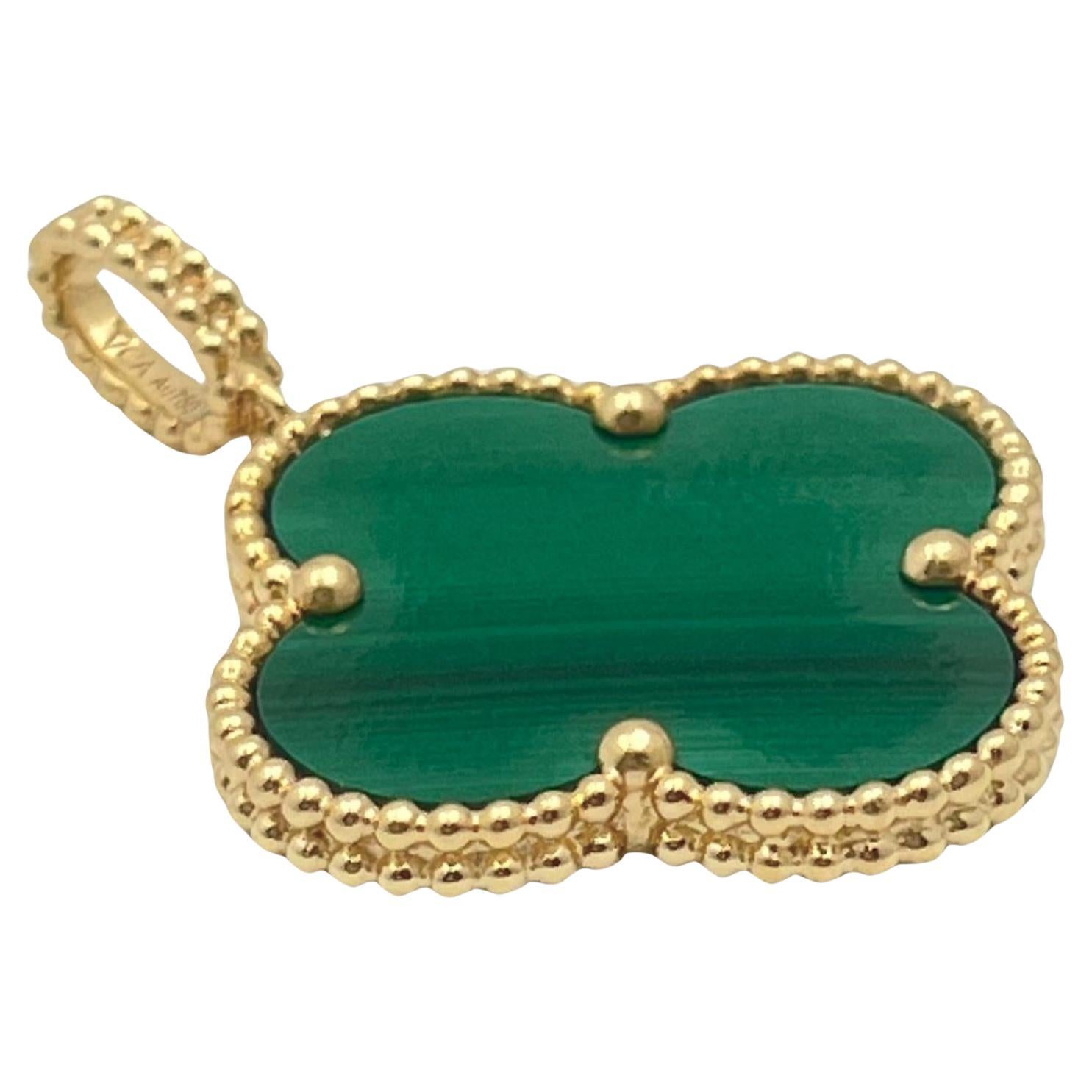 Van Cleef & Arpels 18k Gold Malachite Magic Alhambra Pendant.  Single Magic Alhambra malachite clover measuring approximately 26mm (36mm w/ bail)- Beaded bail top. Signed 'VCA AU750' with serial number. Does not include neck chain.  Includes