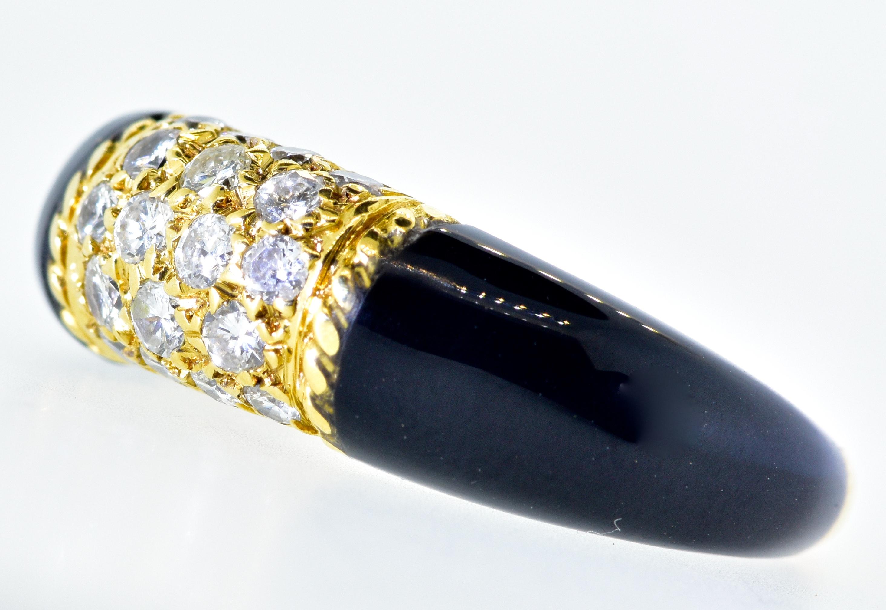 Van Cleef & Arpels, signed and numbered, this charming ring possesses fine white diamonds set into 18K gold and with fancy cut onyx shoulders.  This ring is in fine condition, it is small - a size 3.5, and can be sized slightly.