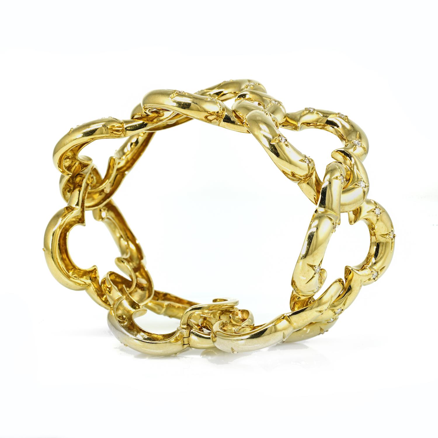 Rare in scale, this vintage Van Cleef & Arpels 18k gold open link Alhambra diamond bracelet is the ultimate statement item in your jewelry box. Consisting of 7 large interlocking quatrefoil links measuring approximately one inch long, the bracelet