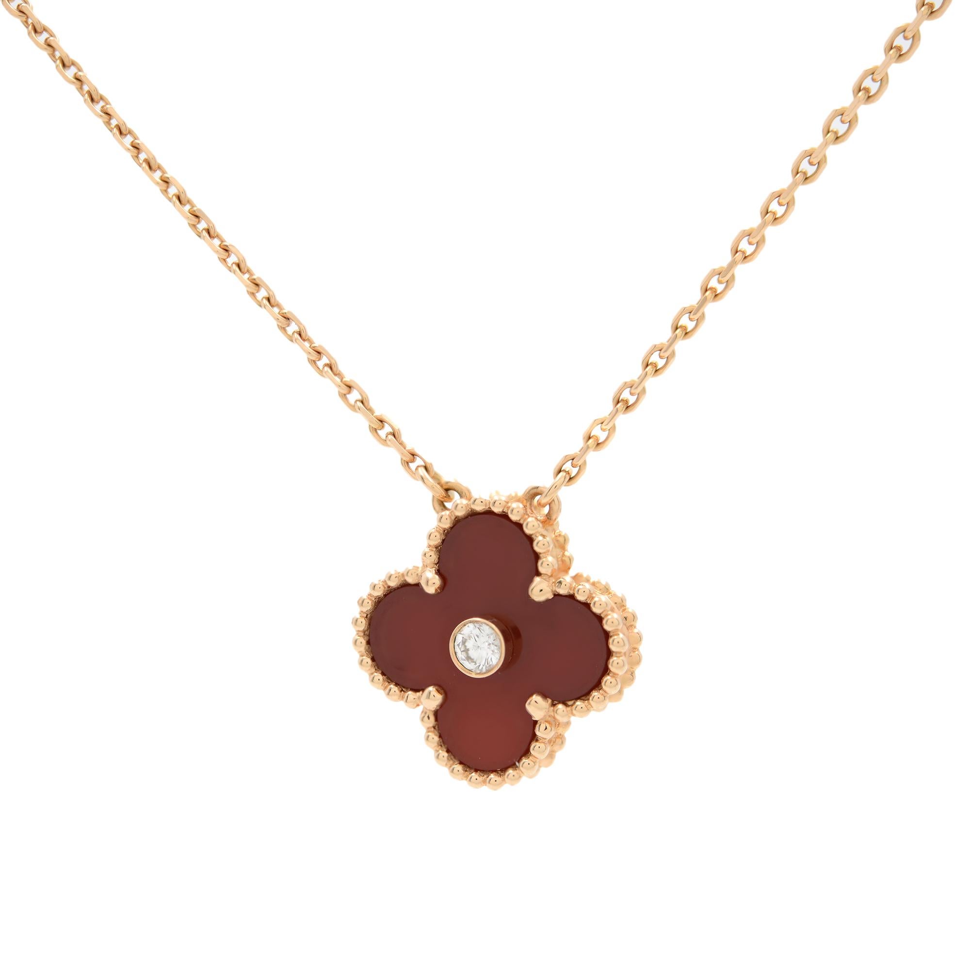 This Van Cleef & Arpels Vintage necklace is crafted in 18k rose gold and features a clover motif pendant set with a carnelian and single diamond weighing approximately 0.05 carats. This is an exquisite necklace with the classical style. Hallmarked.