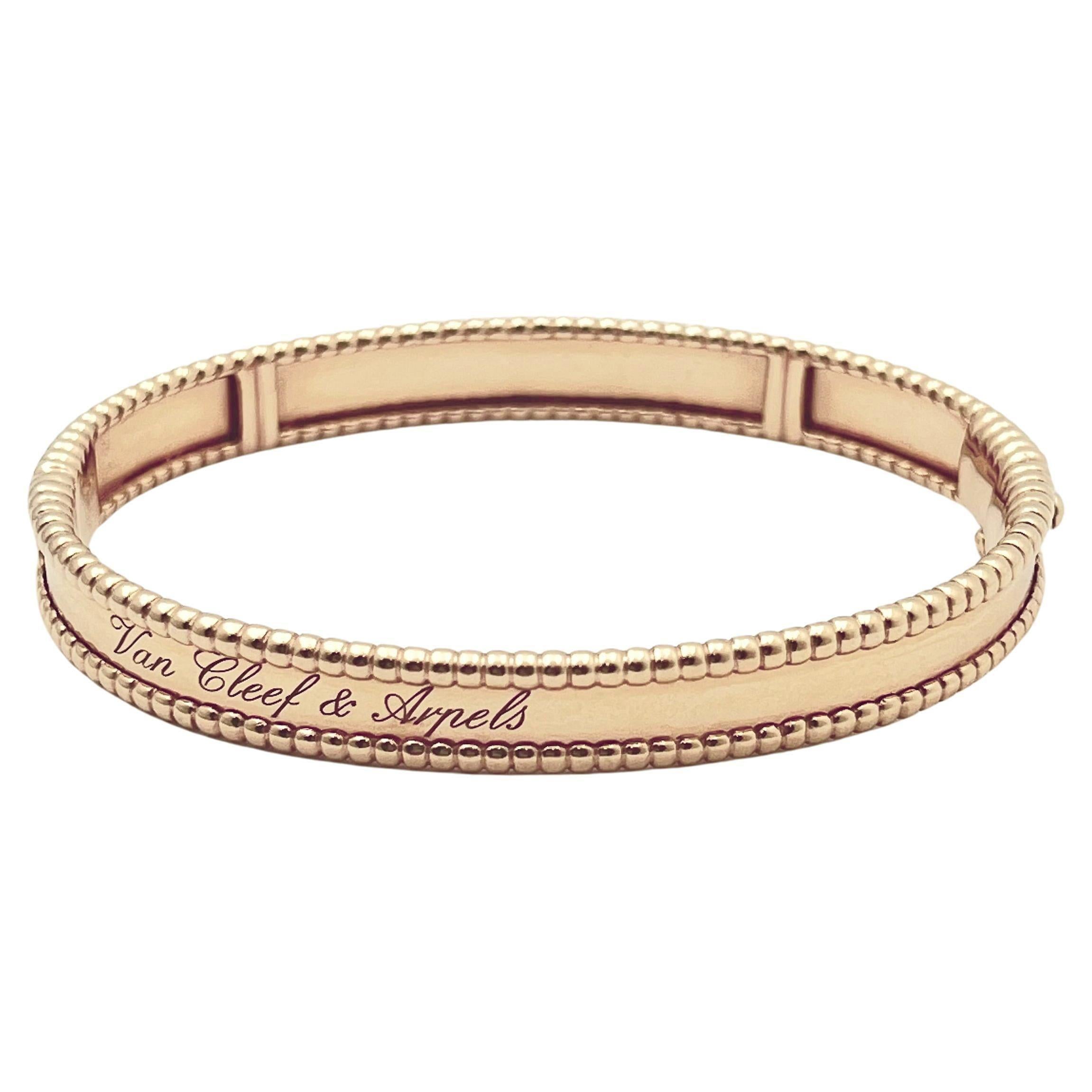 Van Cleef & Arpels medium Perlée signature oval-shaped bangle bracelet in polished 18k rose gold.  Hinged on one side.  Stamped 