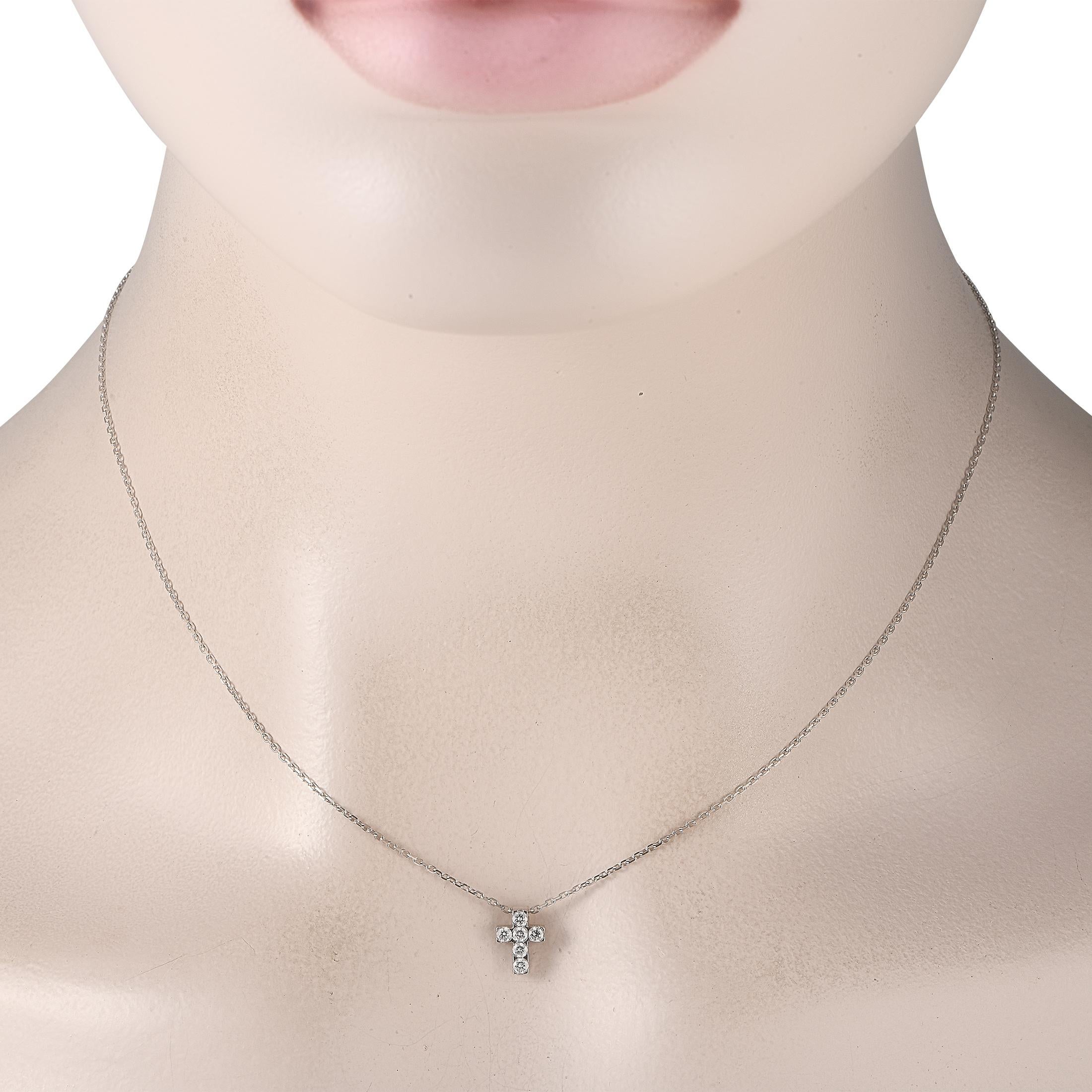 A dainty cross-shaped pendant measuring 0.35 long by 0.25 wide is covered in sparkling Diamonds on this Van Cleef & Arpels necklace. An elegant addition to any jewelry collection, its crafted from 18K White Gold and features a delicate 16 chain.This