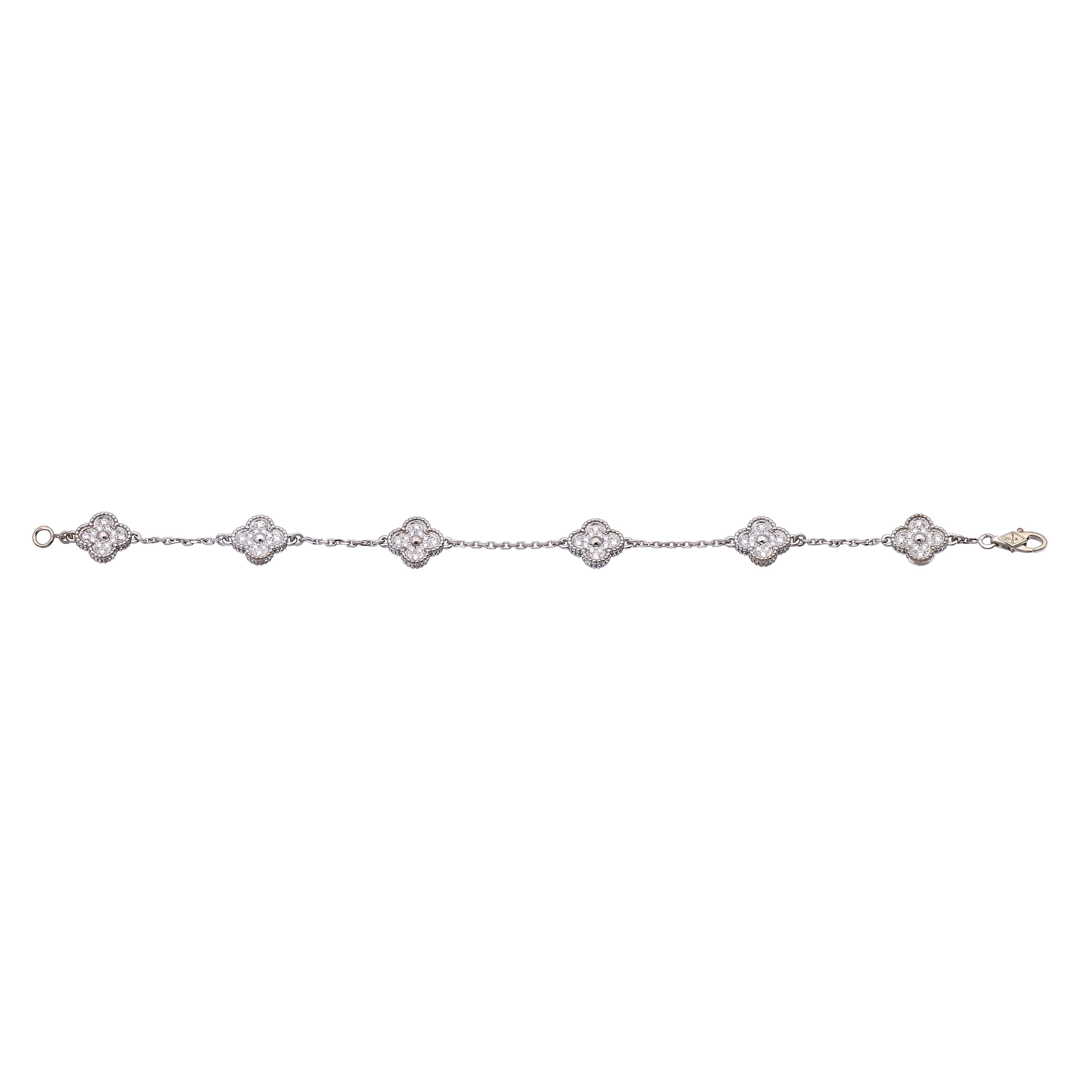 Pre-owned Van Cleef & Arpels bracelet from the Sweet Alhambra collection finely crafted in 18 karat white gold featuring 72 round brilliant cut diamonds all pave set within six delicate clover motifs weighing 0.48 carats total weight portraying the
