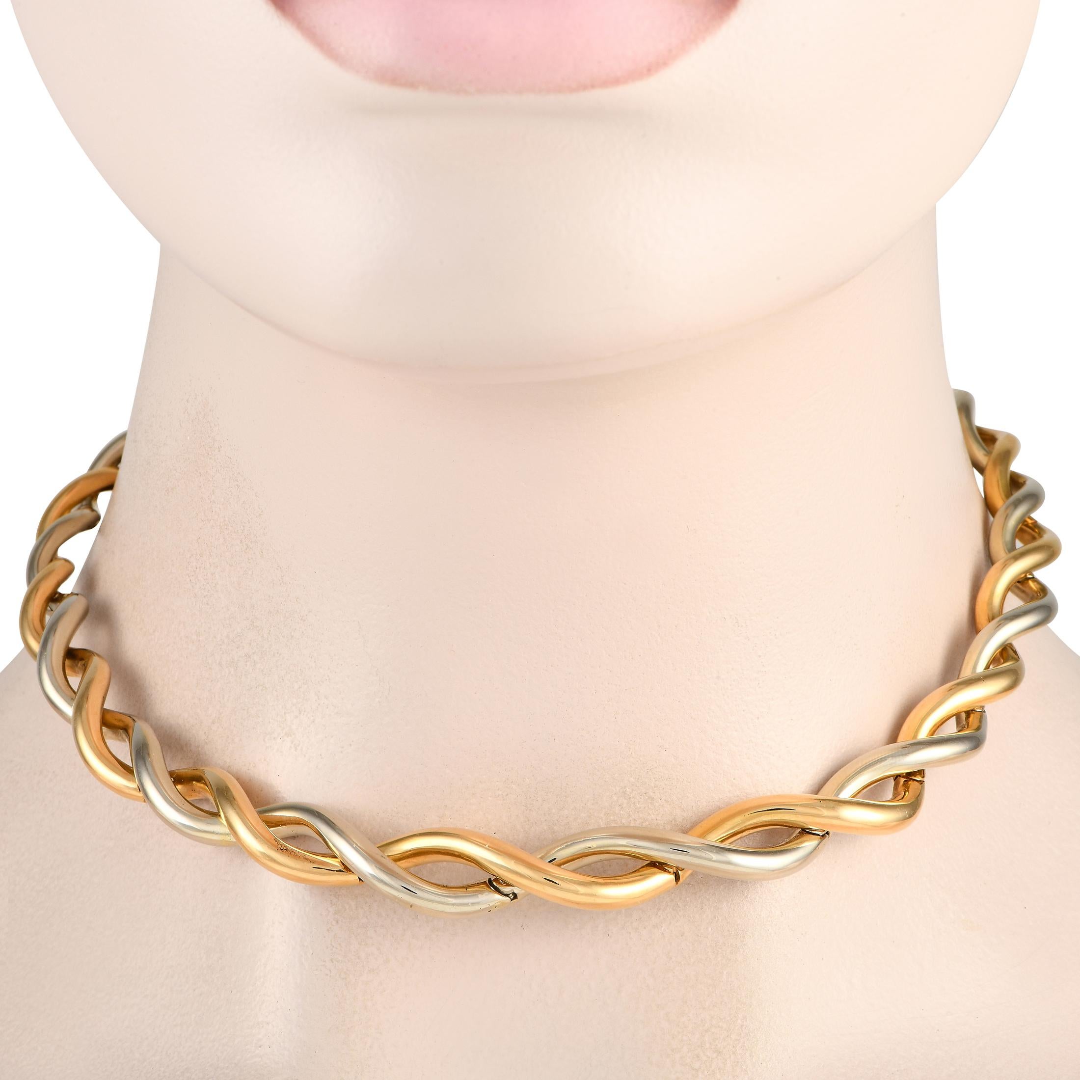 Count on this Van Cleef & Arpels necklace to give any outfit the lift it needs. It features two chunky and curvy cords, in solid 18K white and yellow gold, that twist and overlap. This choker-style necklace sits close to the neck and has a box tab