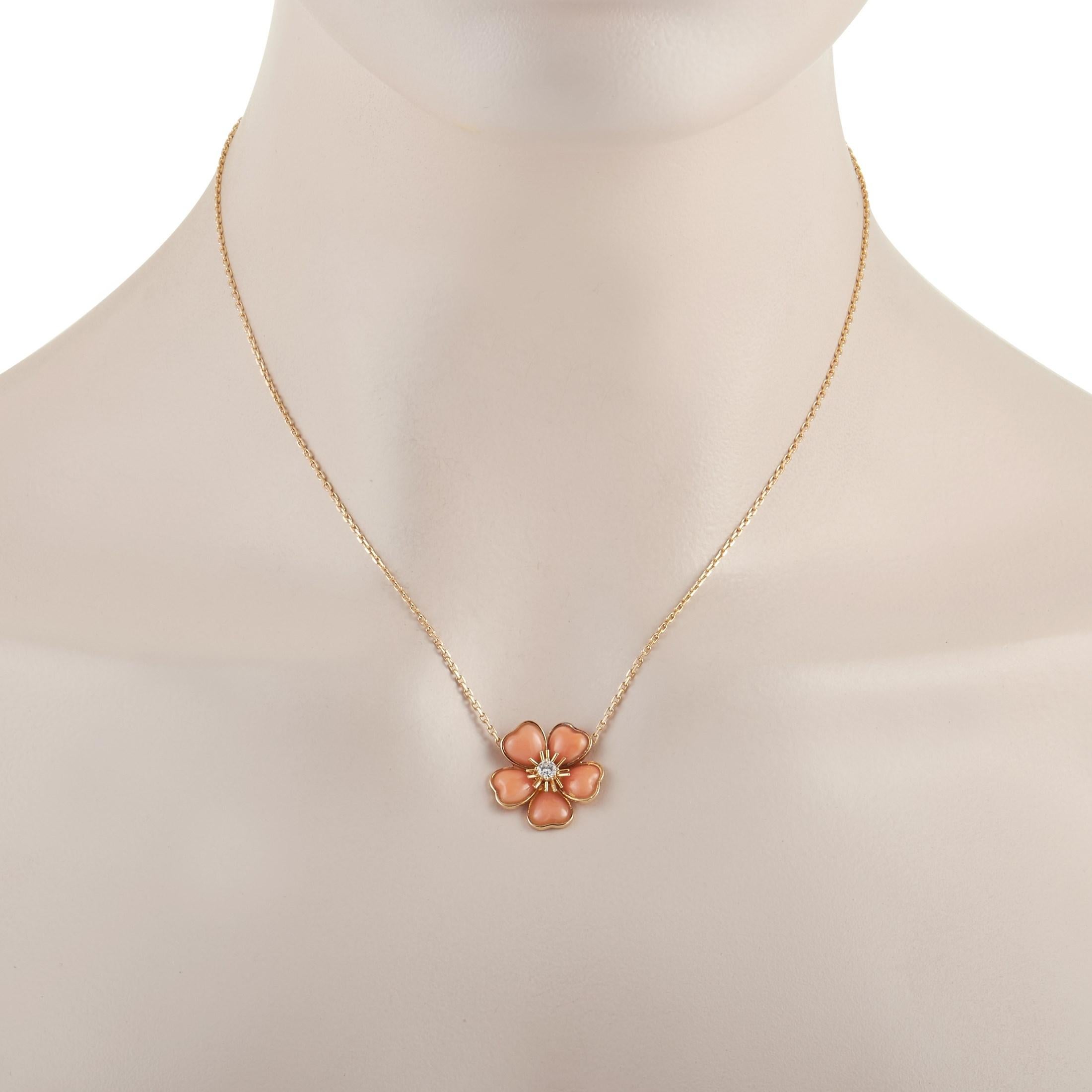 This Van Cleef & Arpels 18K Yellow Gold 0.12 ct Diamond Coral Flower Necklace is made with an 18K yellow gold chain, highlighting a beautiful 18K yellow gold flower pendant. Each flower petal is set with a pretty coral gemstone. The center of the