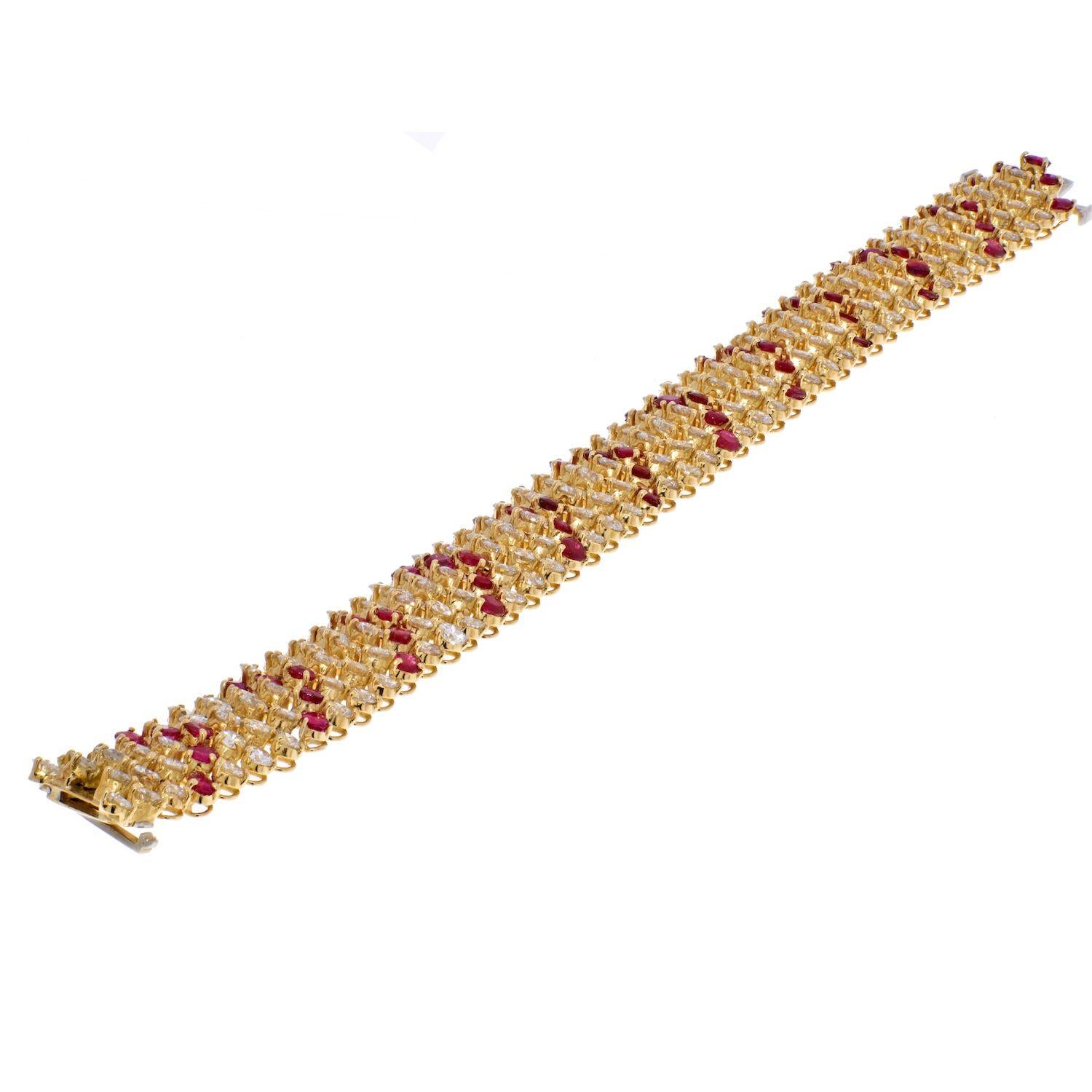 The wide articulated strap of foliate design decorated with diamonds and rubies crafted bt Van Cleef & Arpels. 
Designed as chevrons of 180 round diamonds ap. 23.40 cts., spaced by chevrons of 60 round rubies ap. 9.75 cts., signed VCA NY.
Length 7