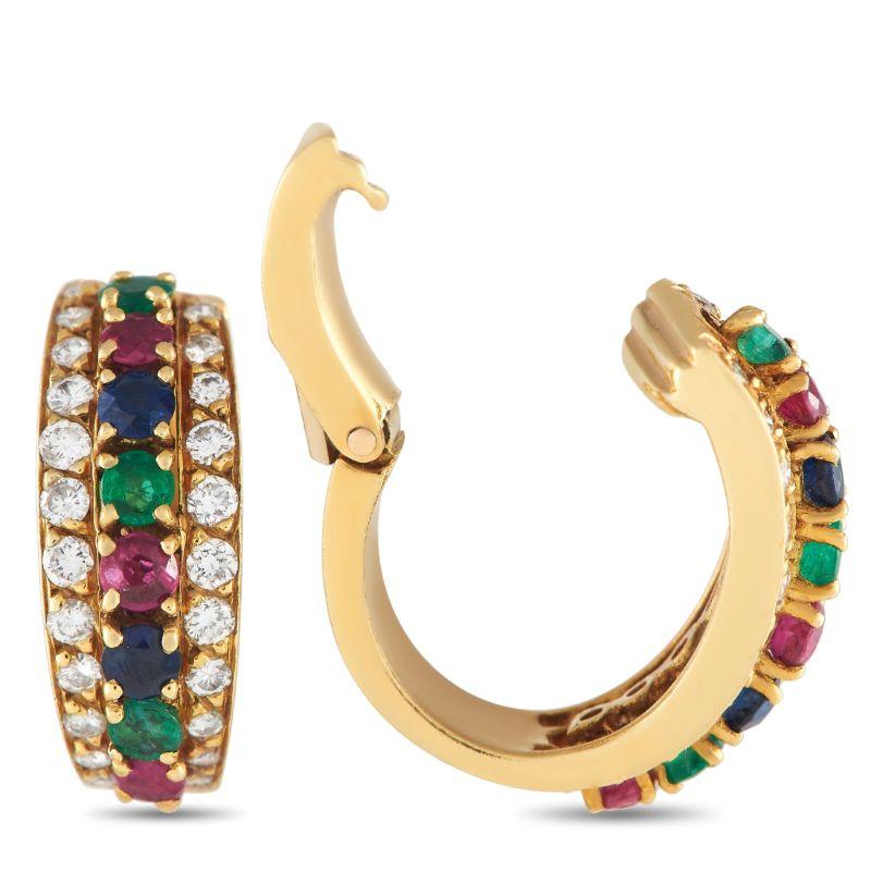These vintage huggie hoops will breathe new life into your daily wardrobe. Each earring with a hinged snap closure sits close to the earlobe. Fashioned in 18K yellow gold, they come lined with three rows of gemstones. At the center is a row of