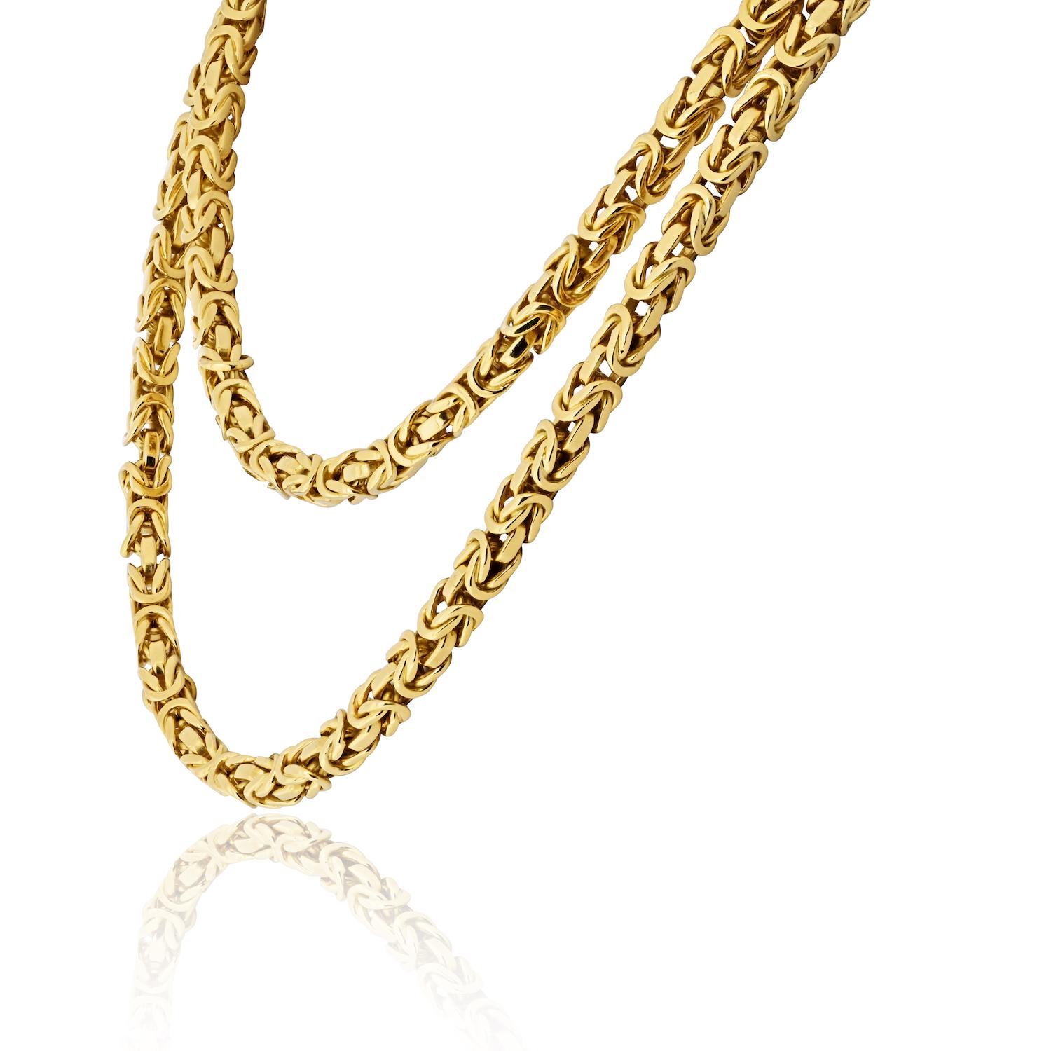An iconic and substantial creation by Van Cleef & Arpels, this 31-inch Byzantine chain necklace is masterfully crafted in 18K yellow gold, weighing an impressive 153 grams. The intricate Byzantine links are meticulously woven, showcasing the