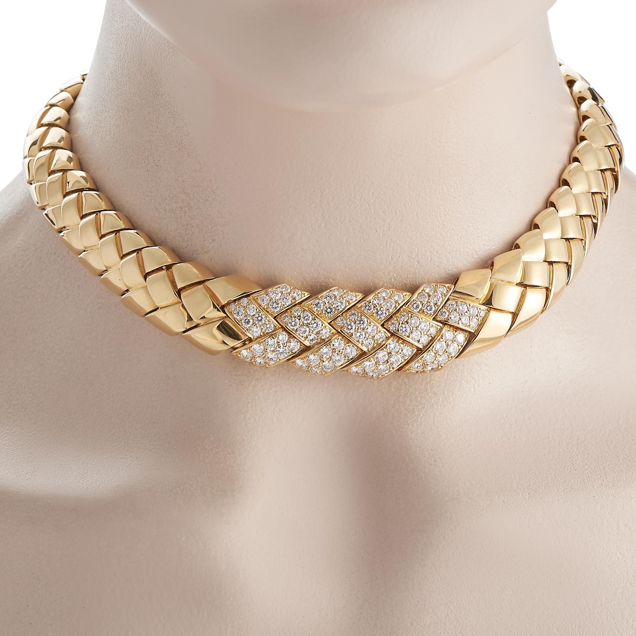 You'll be completely smitten by the dramatic beauty of this collar necklace by Van Cleef & Arpels. It offers a bold look with its yellow gold ribbons woven to form a chunky neckpiece. The diamond-encrusted center ribbons bring a beautiful sparkle to