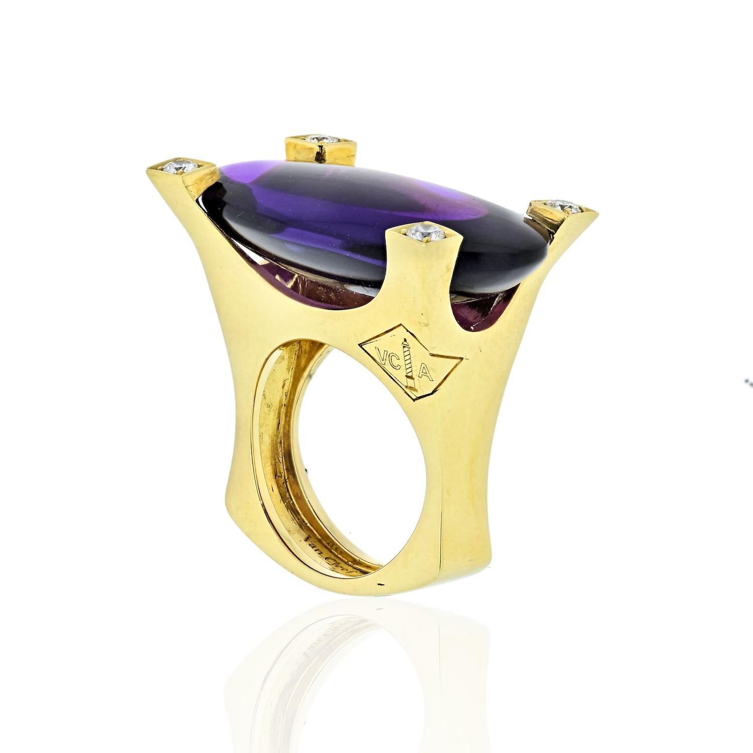 A bold cocktail ring by Van Cleef & Arpels. The central 25 carat oval cabochon amethyst mounted in four heavy claws, each claw set with a single brilliant-cut diamond. VCA logo engraved to the side of the squared shank. Signed VCA and numbered. With