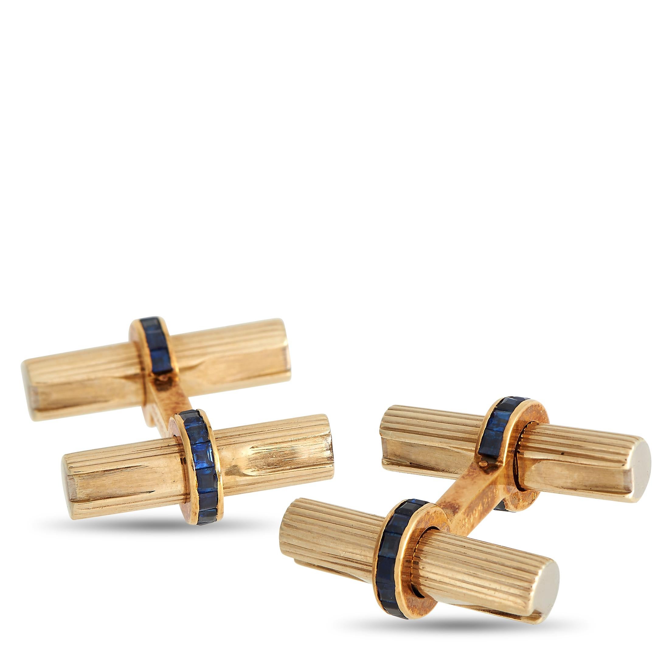 Here is a pair of 18K yellow gold VCA cufflinks to elevate your outfit and express your refined taste. The cufflinks come with a fluted baton design, complemented by hoop terminals with channel-set blue sapphires. Each cufflink measures 0.75 by
