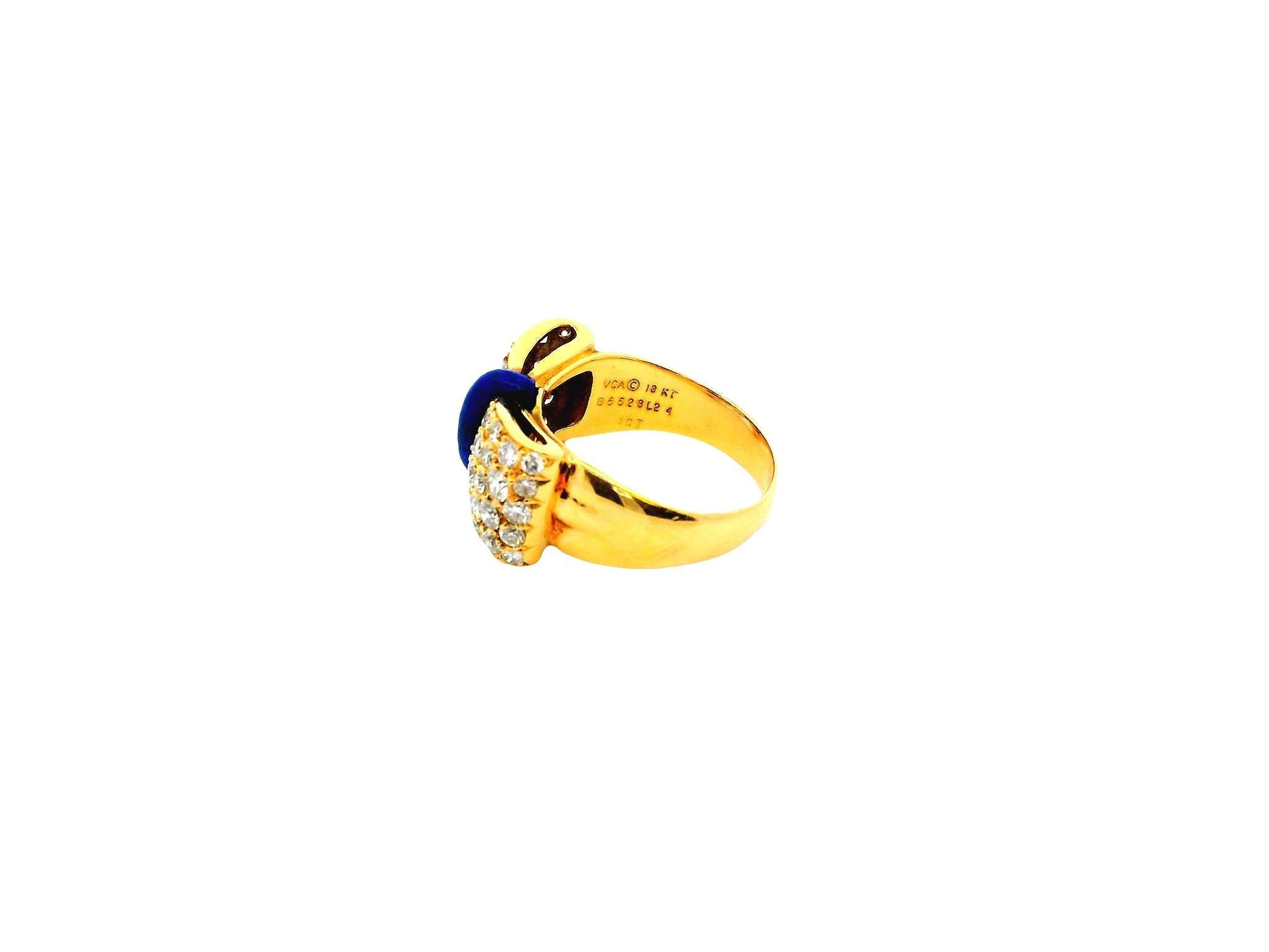 This exquisite ring by Van Cleef & Arpels showcases beautiful craftsmanship in 18k yellow gold. The design features a central blue enamel accent that adds a vibrant touch, while two sections of sparkling round, white diamonds frame it. The diamonds