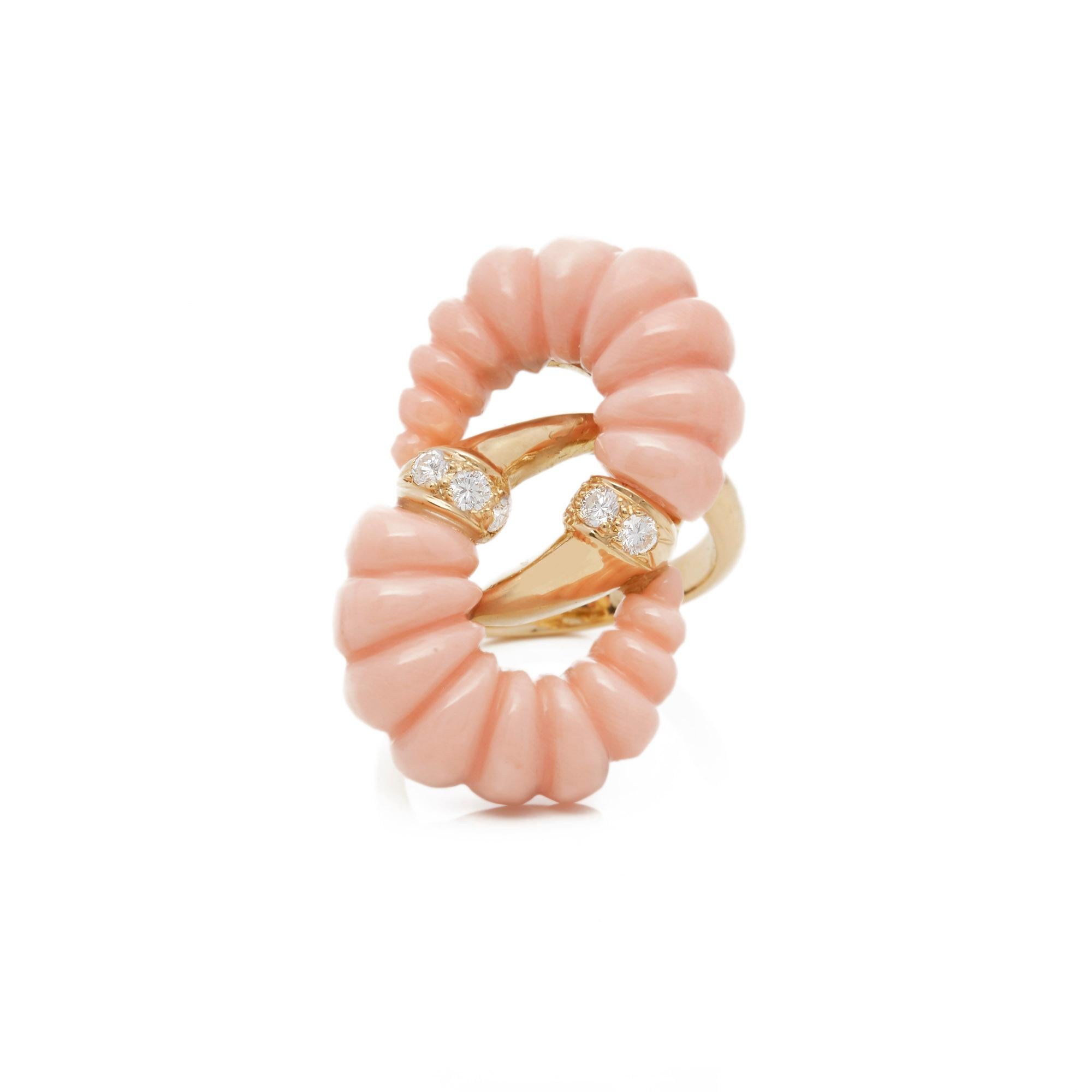 This Ring by Van Cleef and Arpels features two Carved Graduated Pink Coral sections with six Round Brilliant Cut Diamonds mounted in an 18k Yellow Gold band. UK ring size L. EU ring size 53. US ring size 6 1/2. Complete with Van Cleef and Arpels