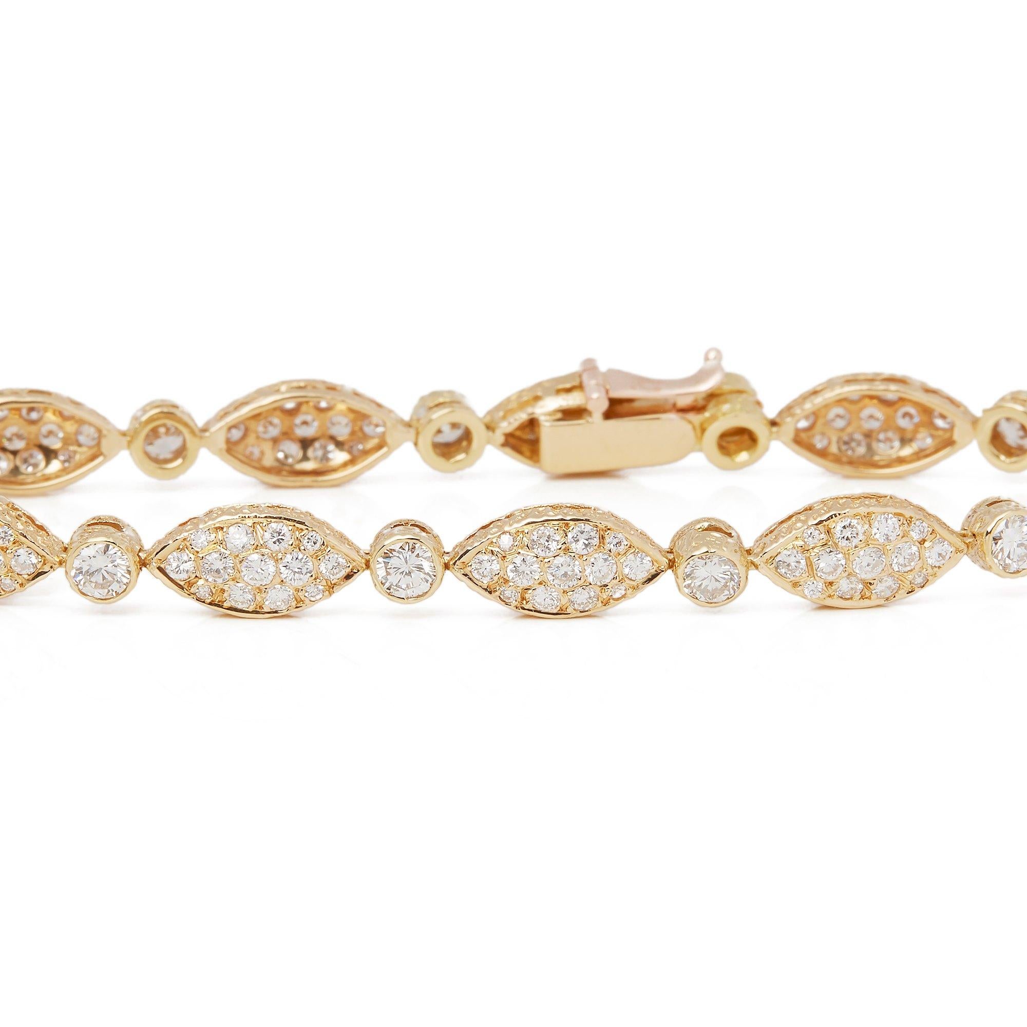 This Vintage Bracelet by Van Cleef and Arpels features Eleven Sections Set with Pave Round Brilliant Cut Diamonds Totalling 4.51cts with indvidual Rub Over Set Round Brilliant Cut Diamonds set in between Totalling 1.10cts. With Tongue Clasp and