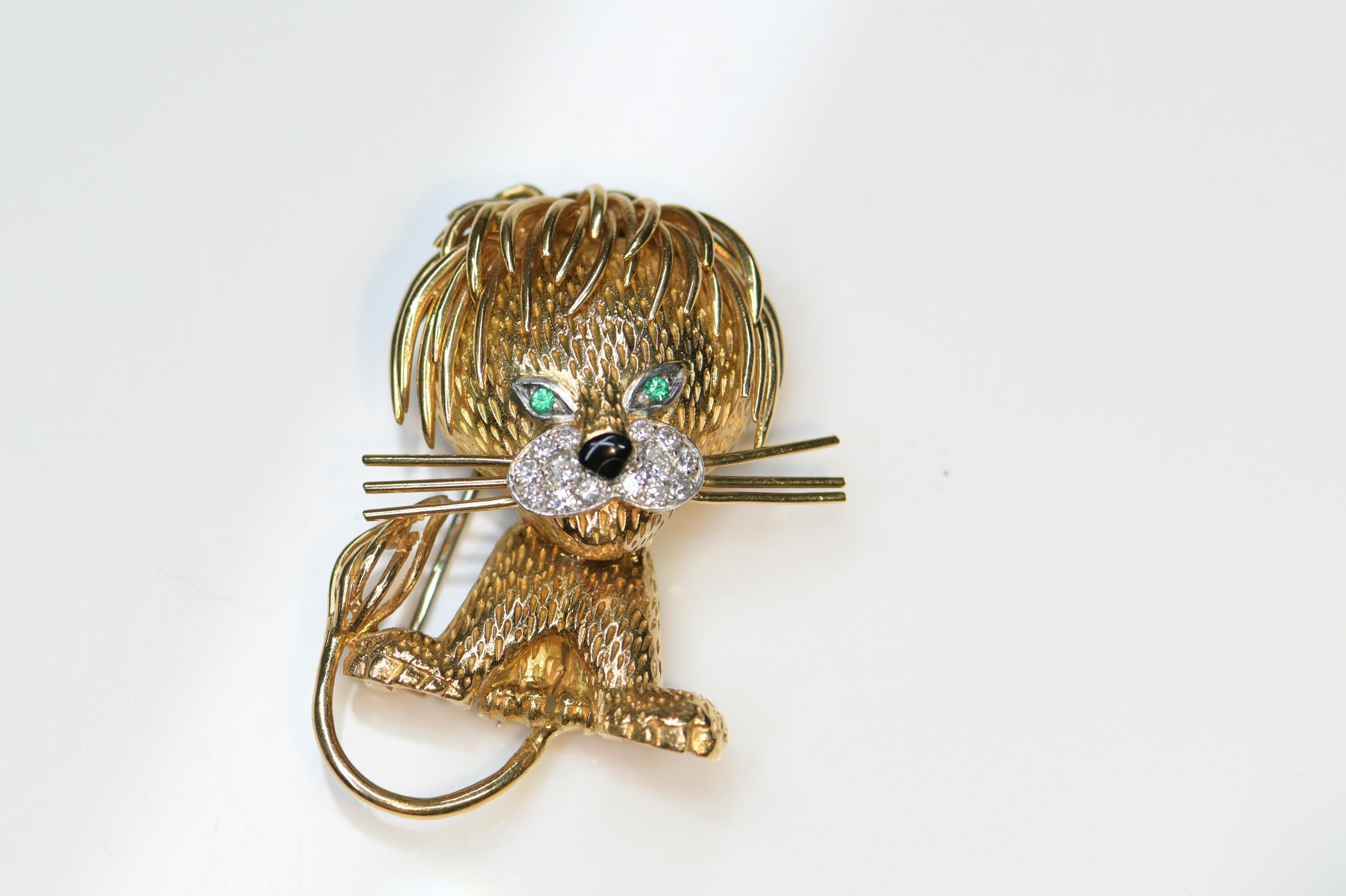 Circa 1970s Van Cleef and Arpels France 18K Yellow Gold Lion Clip brooch, measuring 4.7cm in length and 3.4 cm wide. finely detailed, set with Emerald Eyes and Diamonds around the mouth and further decorated with a Black enamel nose.  This is the