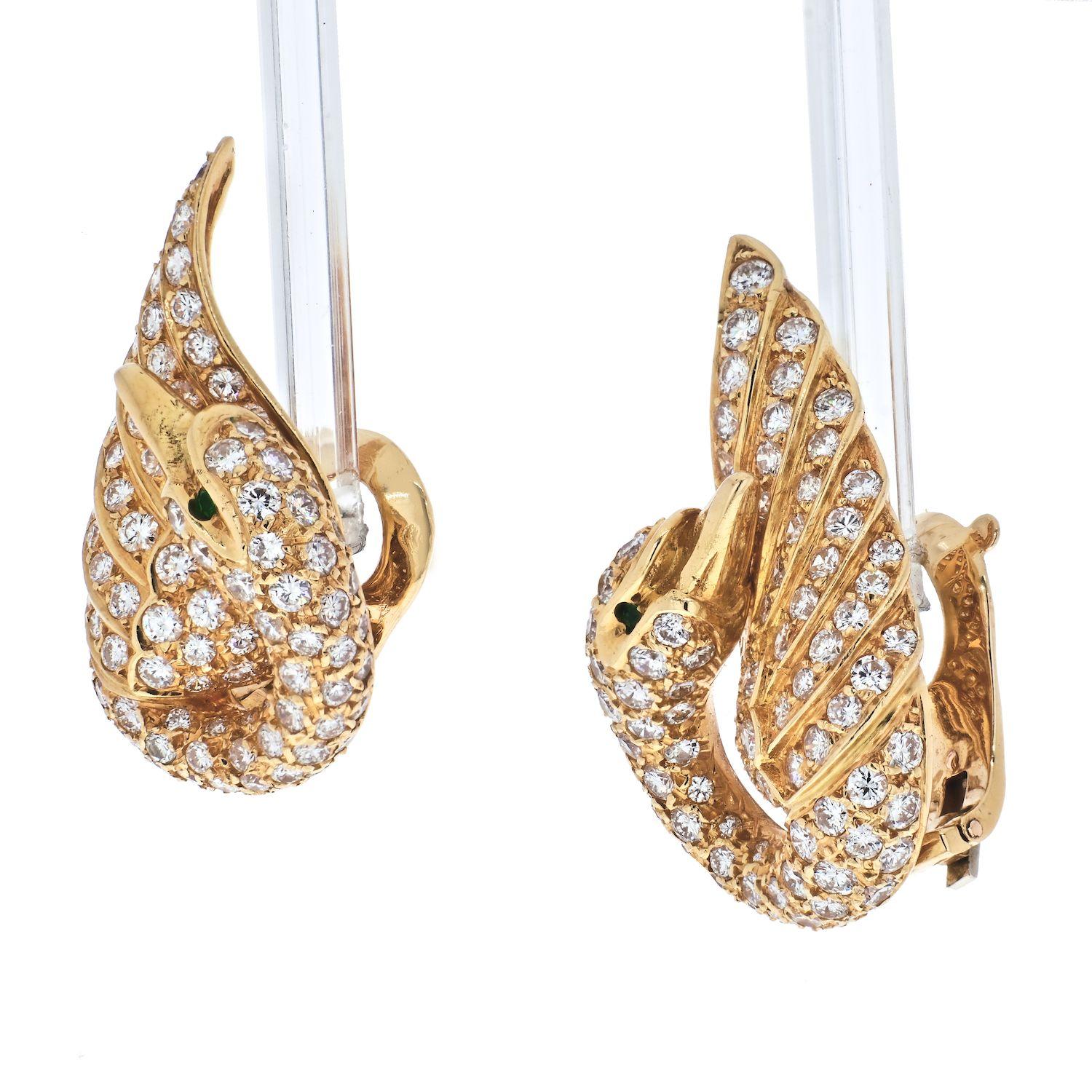 Each designed as a circular-cut diamond swan, with a single-cut emerald eye, 1 3/8 ins., with French assay marks for 18k gold.
Princess Grace owned a pair just like them!
Signed Van Cleef & Arpels, numbered. 
