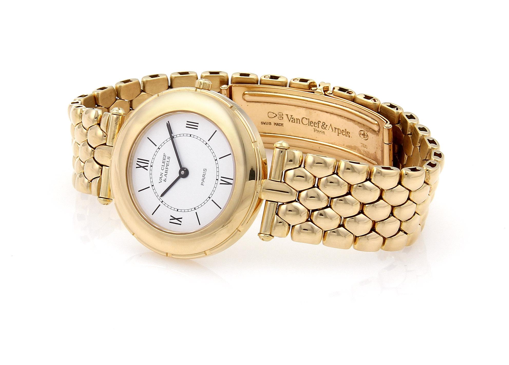 This is an all original and authentic Van Cleef & Arpels quartz ladies wrist watch, the case and band is solid 18k yellow gold with white dial and black Roman numeral hour markers and hands, round 18k yellow gold case with pebble link band which