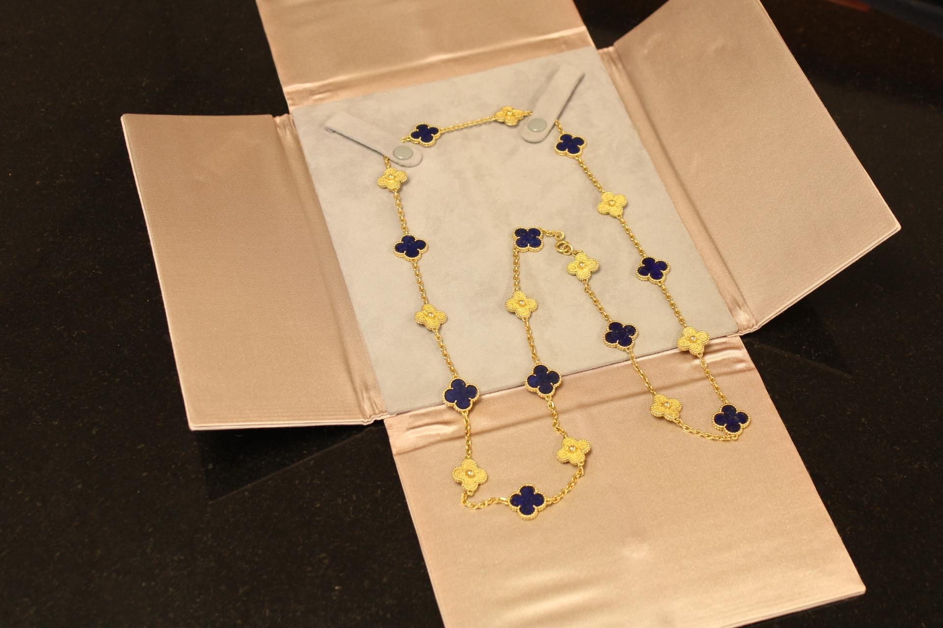 The Van Cleef & Arpels 18K Yellow Gold Vintage Alhambra Necklace is a stunning piece of jewelry that captures the essence of elegance and sophistication. This necklace features a total of 20 motifs, including 10 vibrant lapis lazuli designs that add