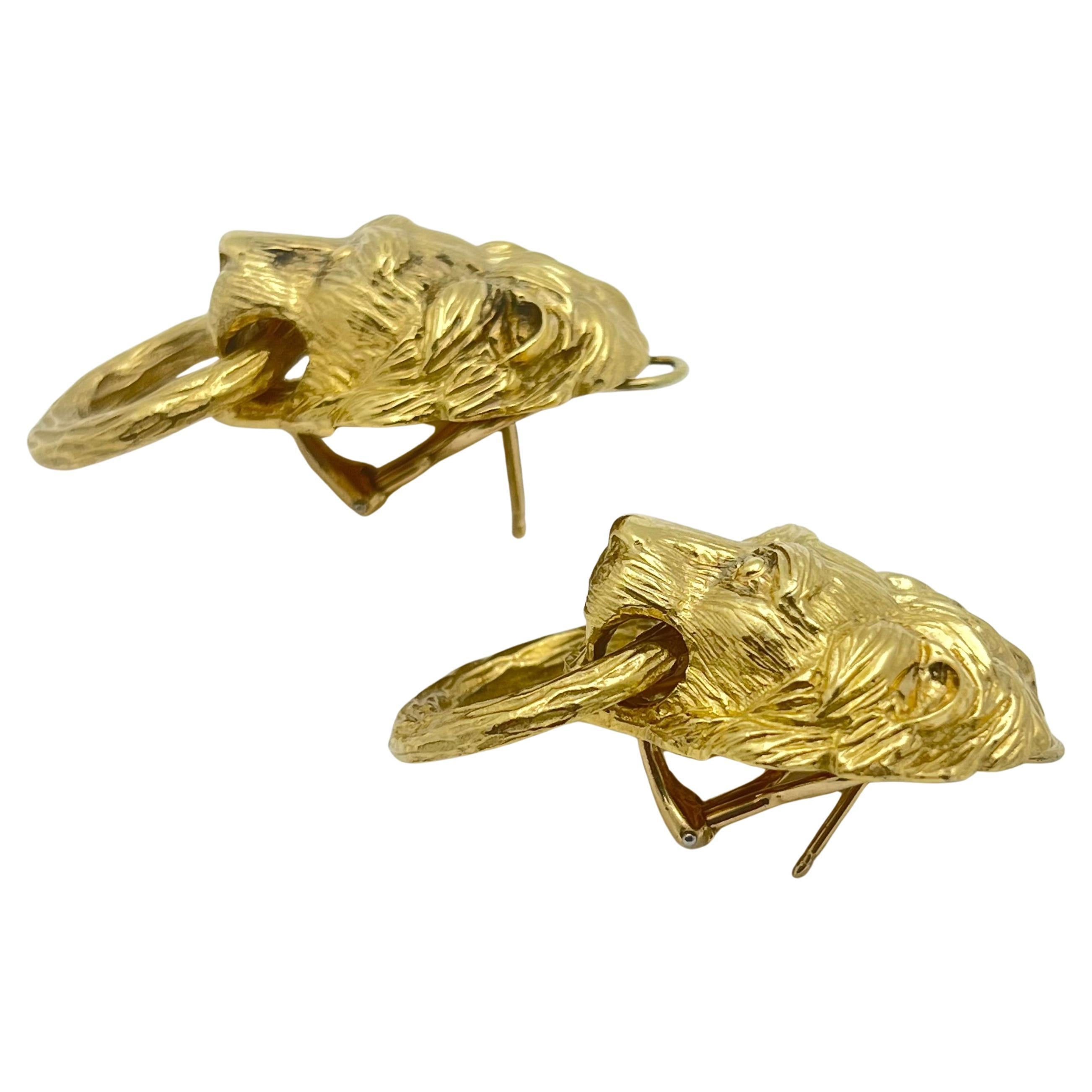 Van Cleef & Arpels lion head doorknocker earrings in textured and polished 18k yellow gold.  Omega clip backs with posts.  Signed 'VCA' and numbered '3V523-62' on reverse of one earring.  Circa 1970.  Measuring 1.5