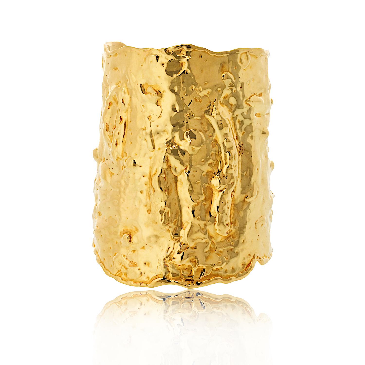 This Van Cleef & Arpels Manchette hammered cuff bracelet is a stunning piece with its iconic hammered finish. 

Crafted in solid 18k yellow gold, it’s both luxurious and substantial, weighing approximately 160 grams. With a wrist size of 5.75 inches