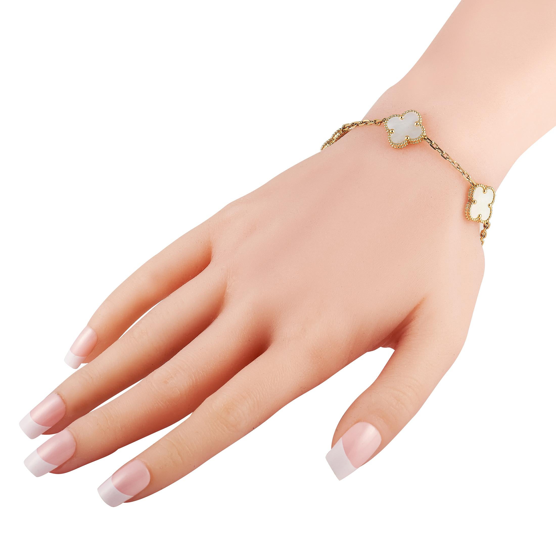 The iconic Van Cleef & Arpels clover motif makes a statement on this stylish luxury bracelet. Crafted from 18K Yellow Gold, glistening Mother of Pearl elevates the series of five Alhambra accents on this 7.75