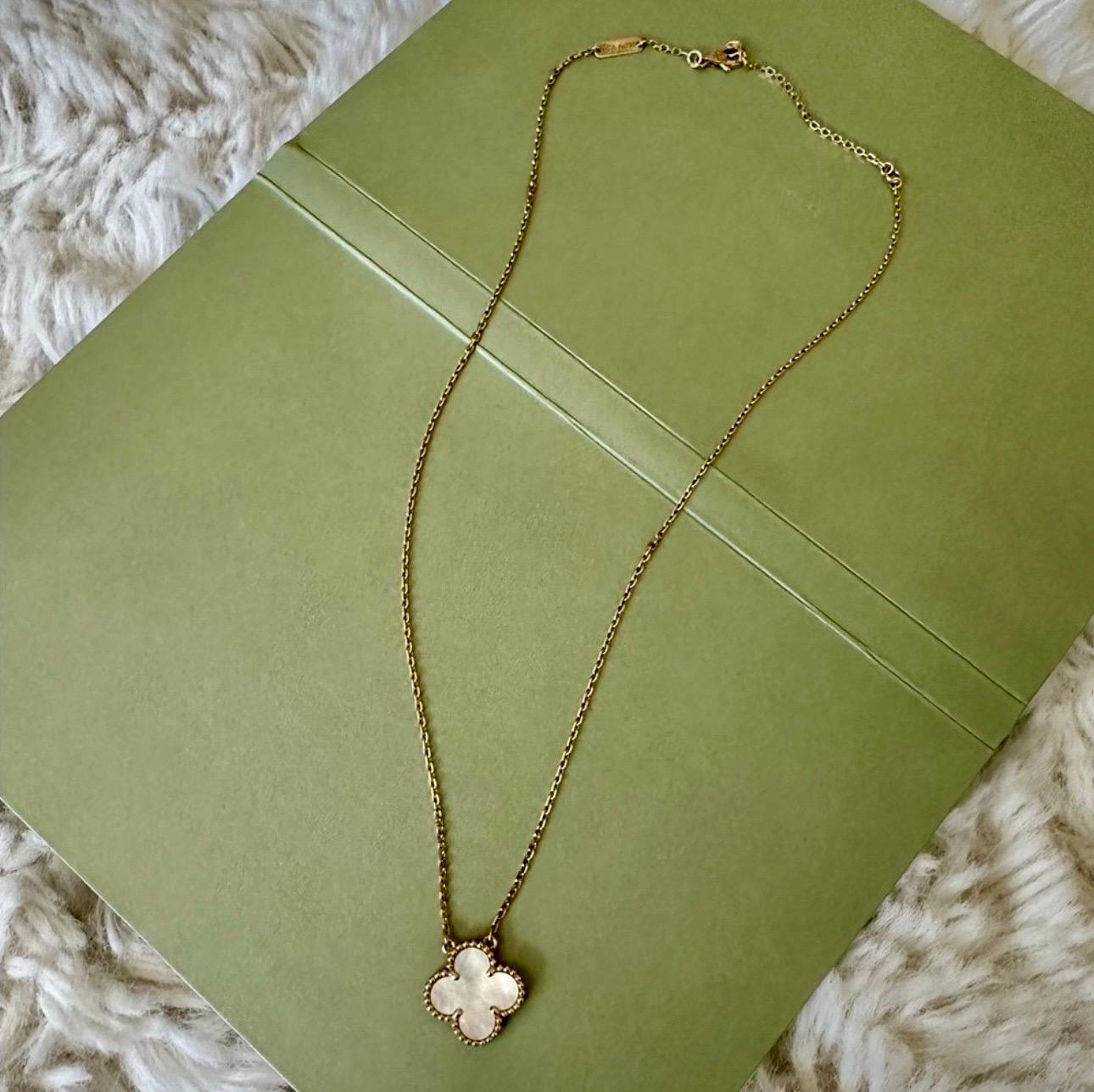 This classic Van Cleef & Arpels Necklace from the iconic Vintage Alhambra collection is crafted in 18k yellow gold and features 1 lucky clover motifs of 10.66 mm  Pendant beautifully inlaid with White Mother of Pearl in round bead settings. Made in