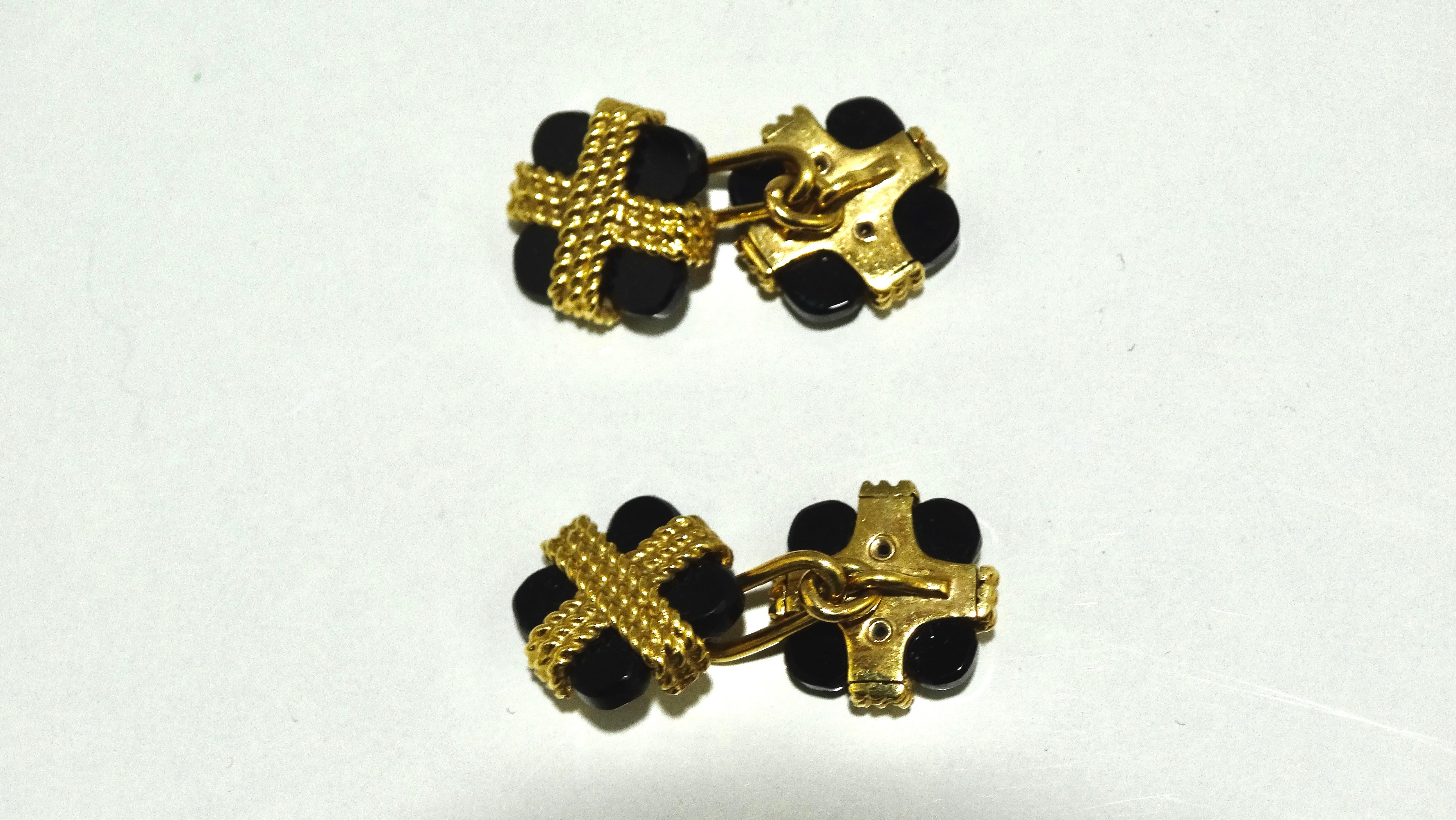 This is a wonderful pair of cufflinks from the luxury jewelry designer Van Cleef & Arpels cira 1970s. The cufflinks features a square onyx wrapped in an 18k gold rope style design. These versatile cufflinks would look sharp paired with your Rolex or