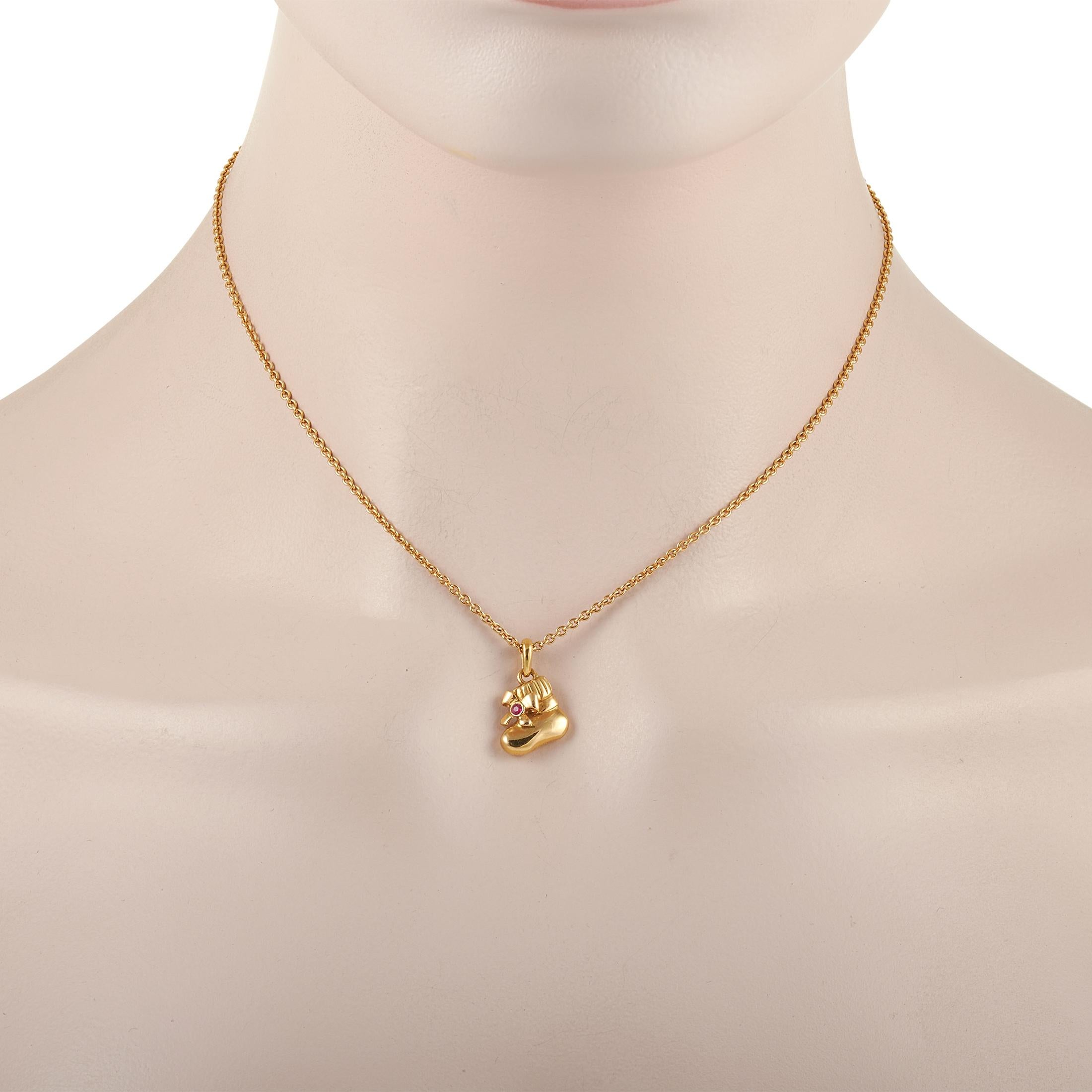This sweet Van Cleef & Arpels 18K Yellow Gold Ruby Shoe Pendant Necklace is crafted from 18K yellow gold chain and features a yellow gold shoe pendant that is set with a round ruby. The dainty chain measures 15 inches in length and features a spring
