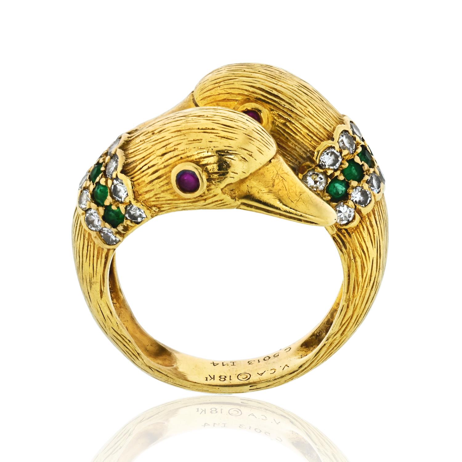 Vintage Van Cleef & Arpels Gold Twin Duck Head Crossover Ring. Set with circular-cut diamonds, emeralds and rubies. Signed VCA, numbered, French hallmarks and marker's marks. Grafted in 18k yellow gold. Weight: 9.20 grams. Ring size 7. Great