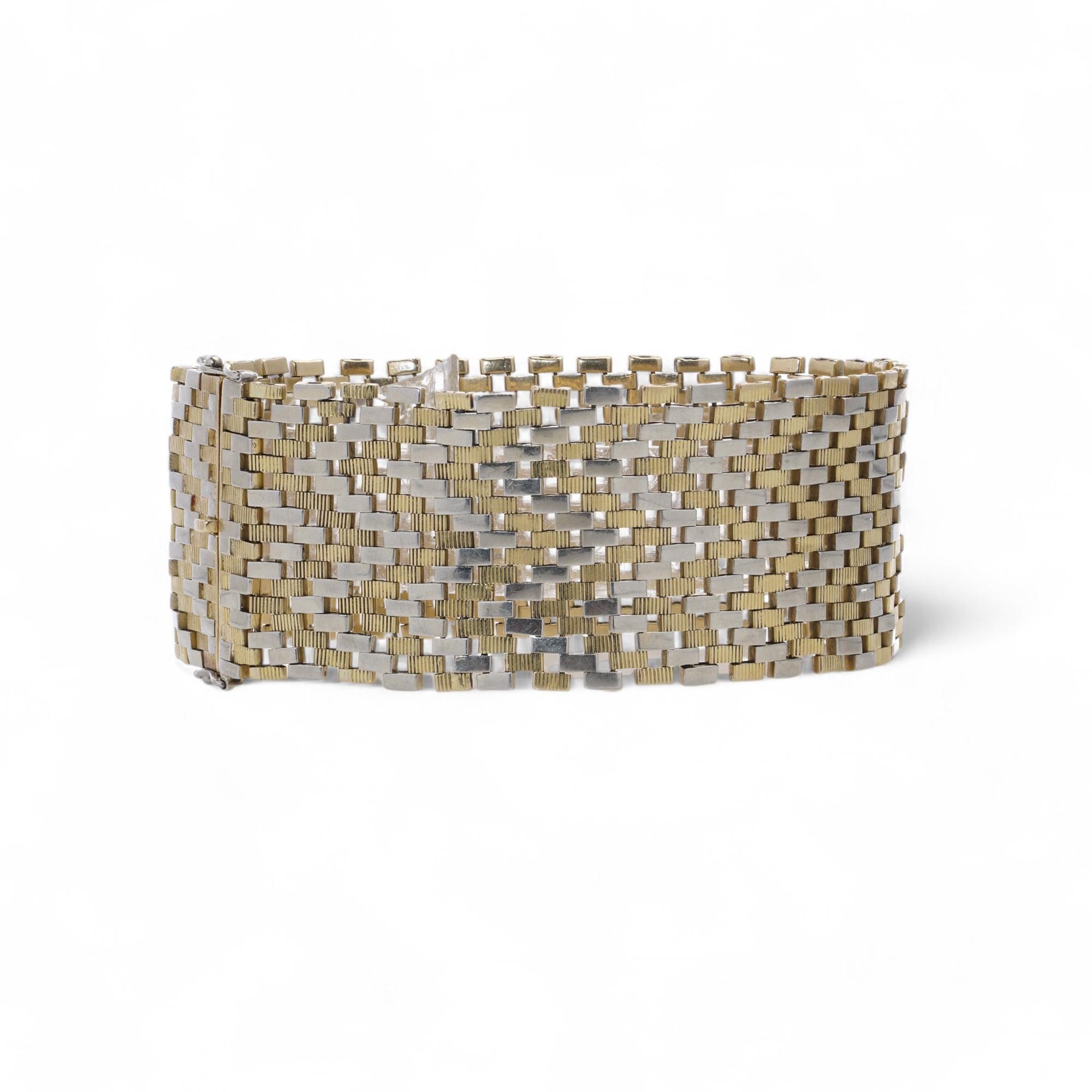 Van Cleef & Arpels 18kt Yellow and White Gold Bracelet.

This bracelet by Van Cleef & Arpels is crafted in 18kt yellow and white gold, featuring an elegant chevron-patterned design. Made in France during the Retro period circa 1930-1940, it carries