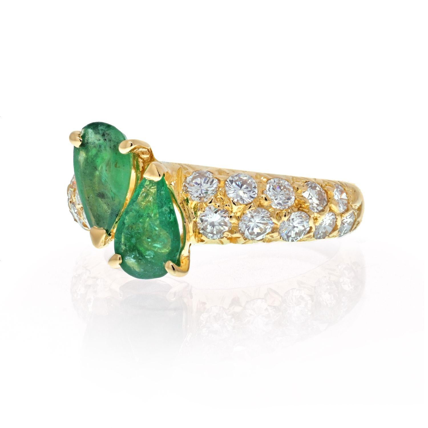 Vintage Van Cleef and Arpels 18K yellow gold cross-over or toi et moi ring consisting of 2 pear shaped green emeralds weighing 3.00 carats in total. Can serve as a lovely promise or an engagement ring. 
This style of ring has been popular as an