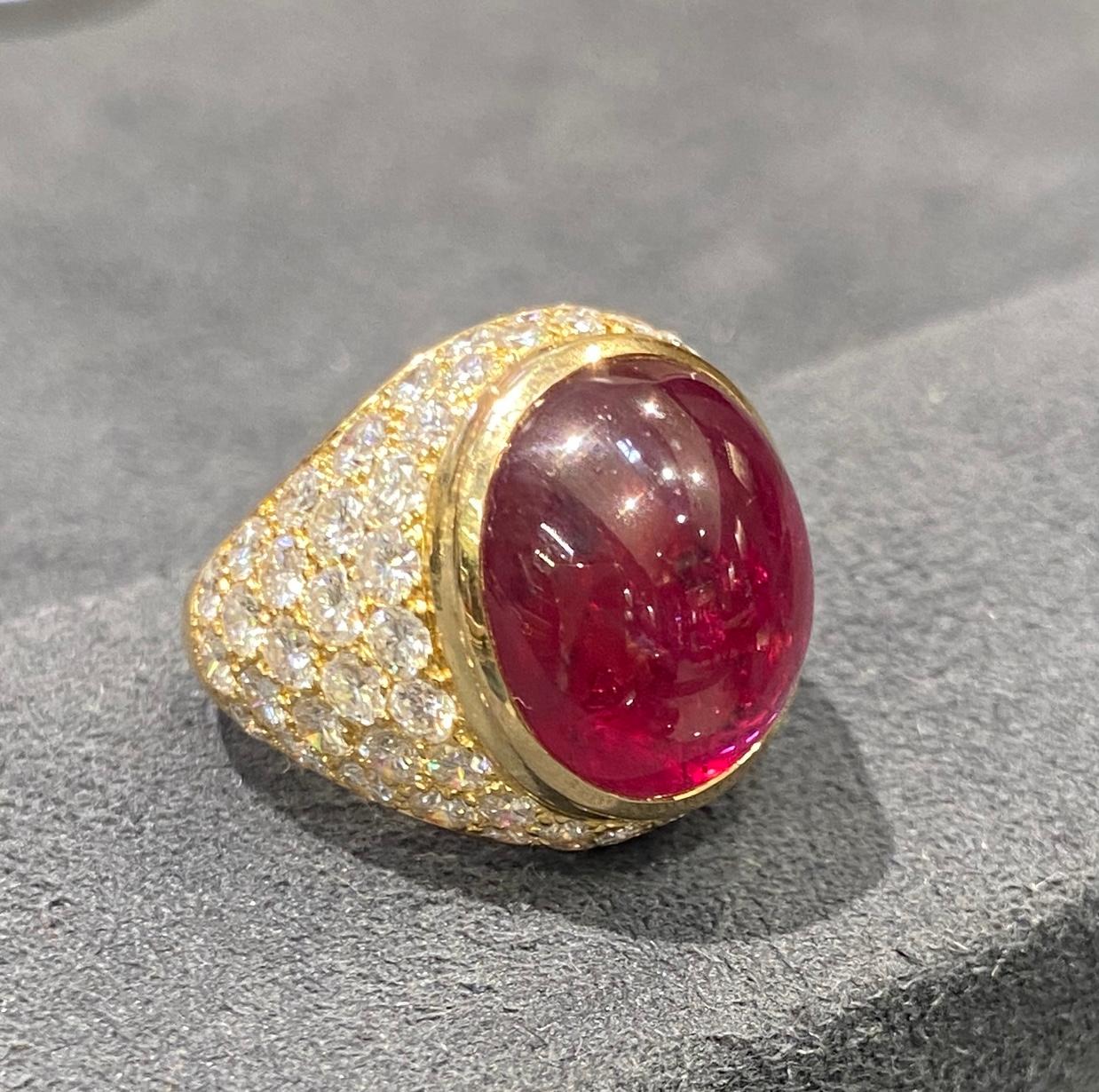 This striking 1960s Van Cleef & Arpels ruby and diamond ring has a central cabochon ruby of approximately 10 carats and approximately 3 carats round cut diamonds. Made in France, it is a timeless beauty that is as comfortable to wear as it is
