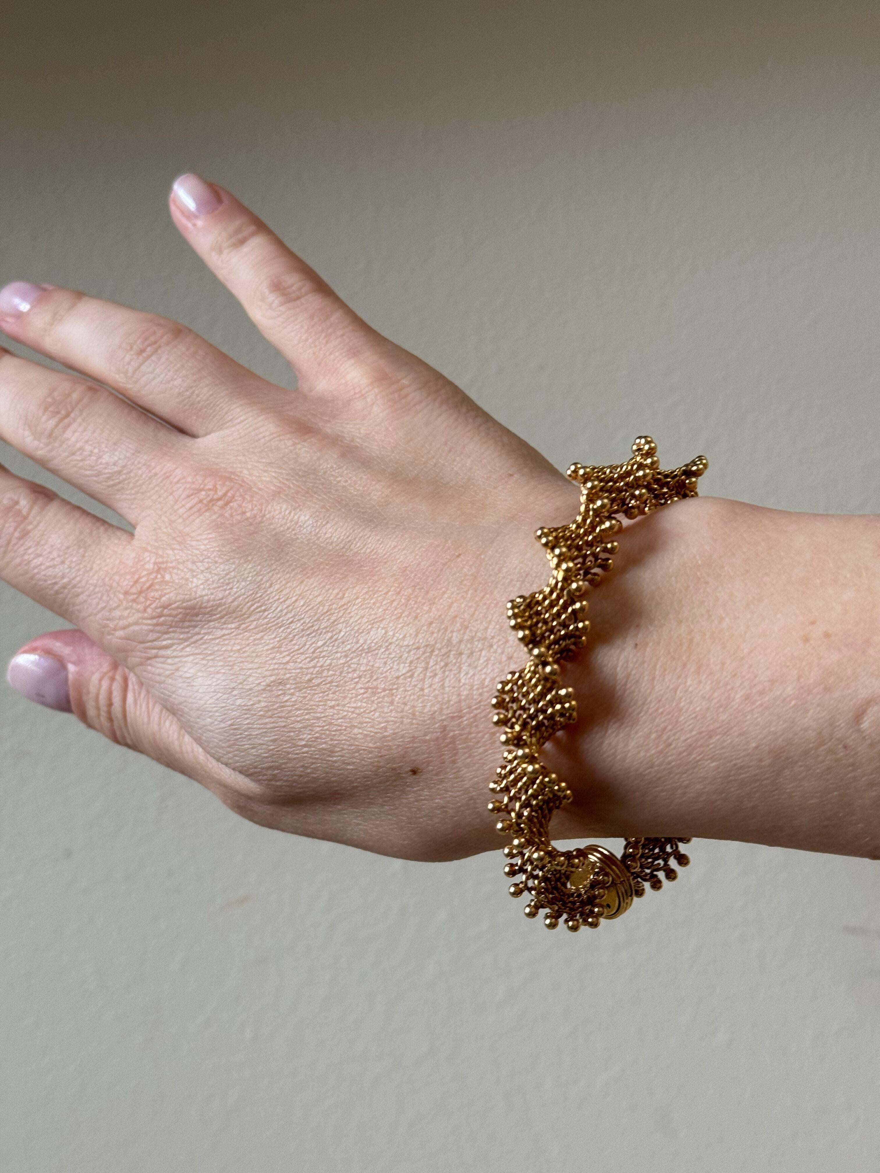 1960s vintage 18k gold bracelet by Van Cleef & Arpels, featuring twisted beaded links. The bracelet is 7.75
